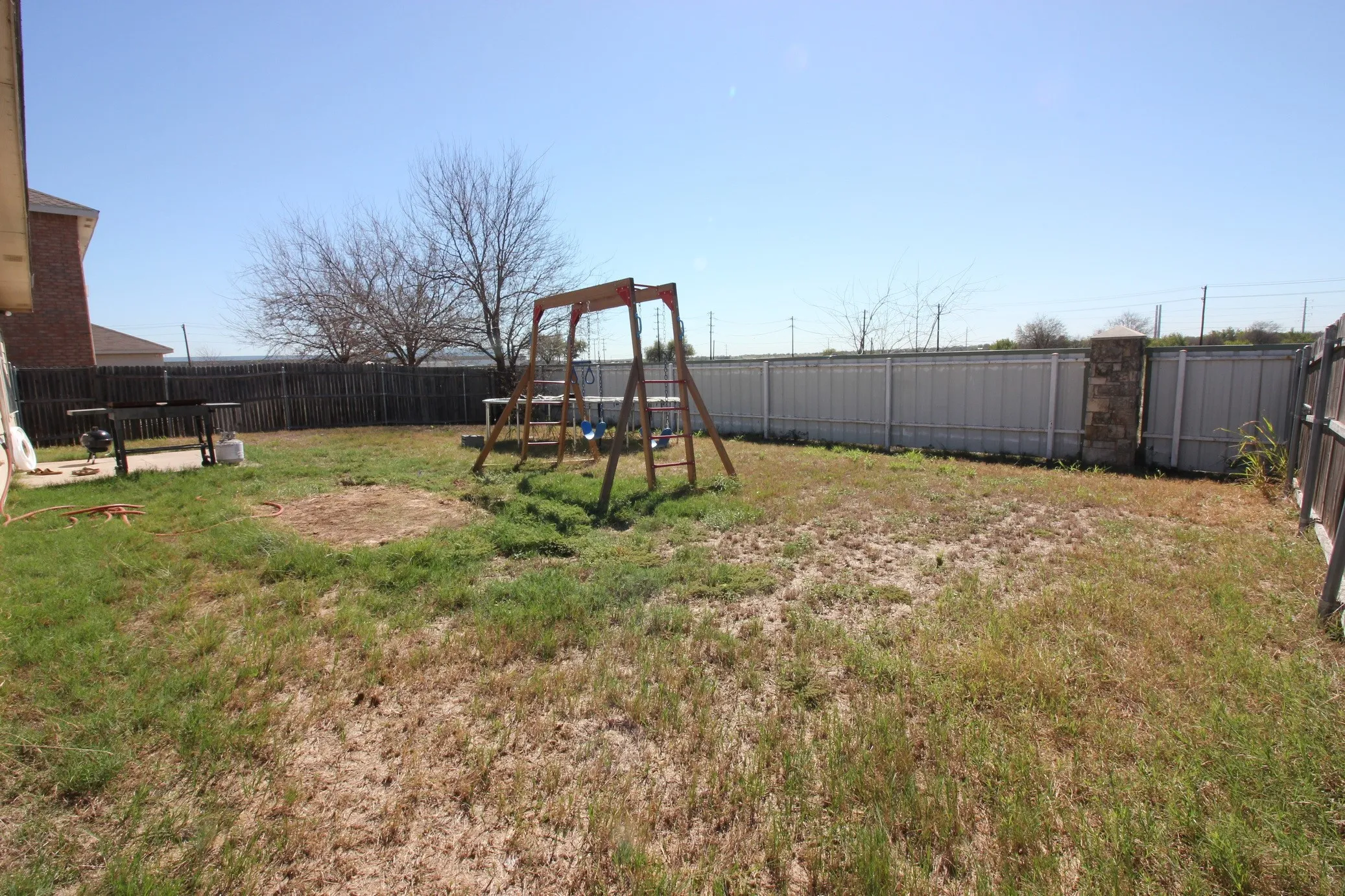 Expansive backyard with a combination of wood and metal fencing
