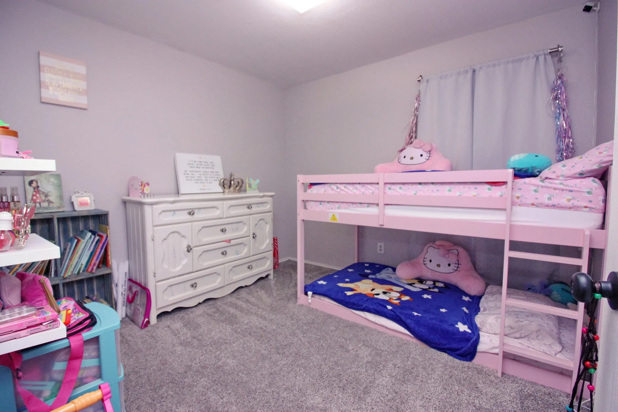 Carpeted flooring, recessed ceiling lighting, light gray wall paint, and a built-in wall shelf system