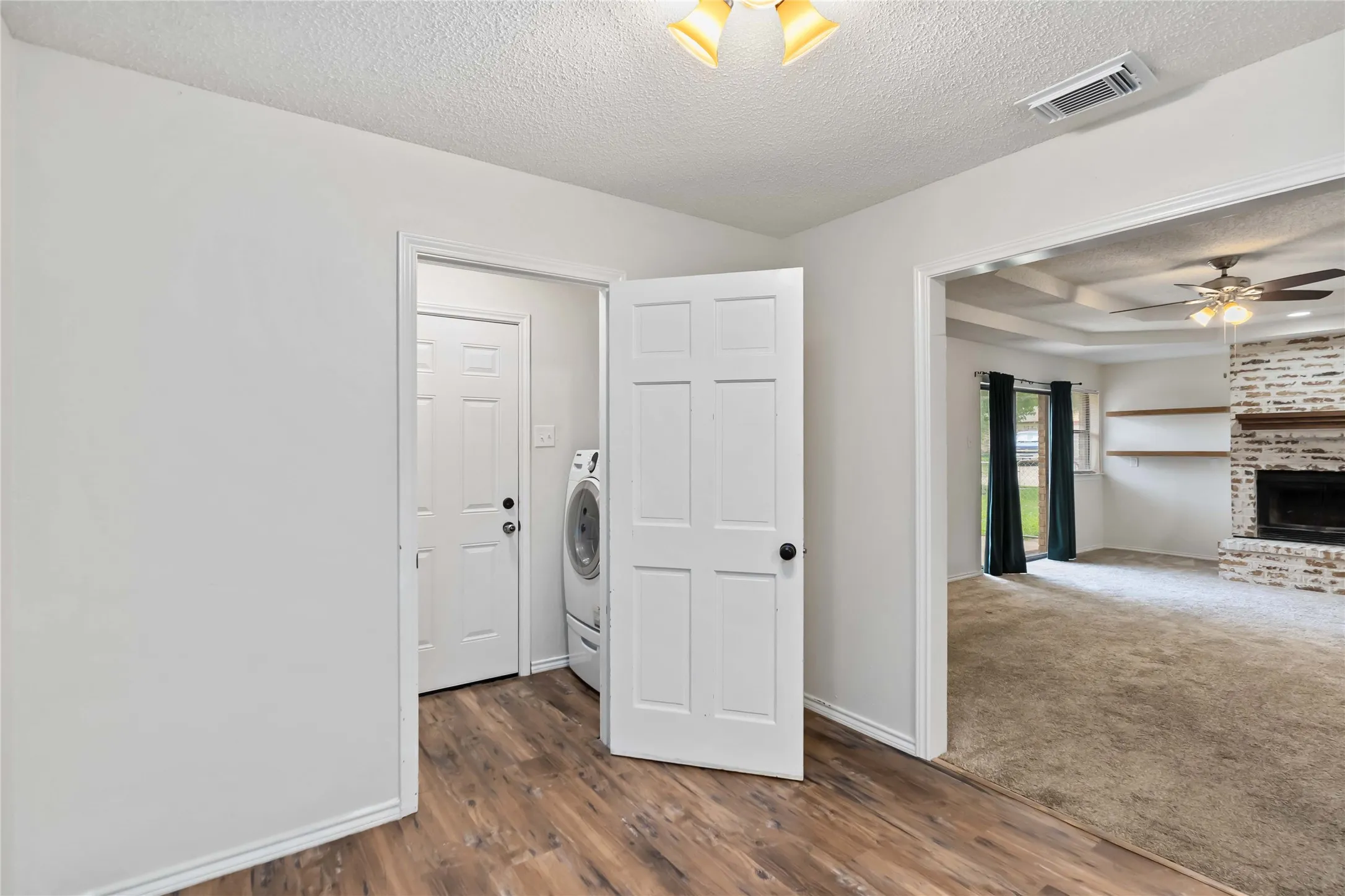 Utility area featuring wood-finish flooring