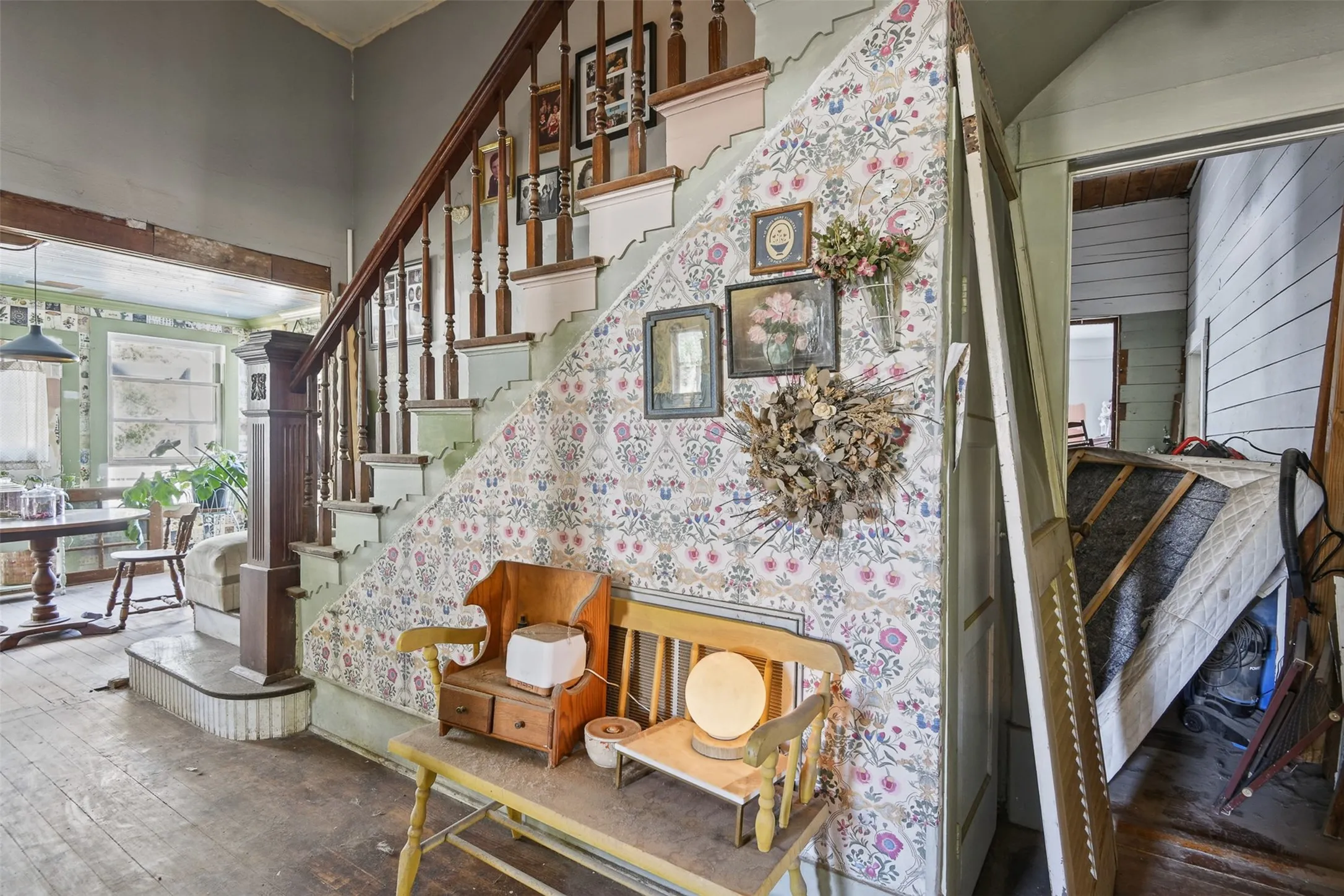 Foyer hallway from living room/sitting room to bottom of stairs and sunroom/eat in kitchen area.