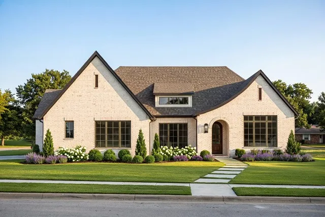 White brick exterior with dark trim accents and a dark shingled roof
