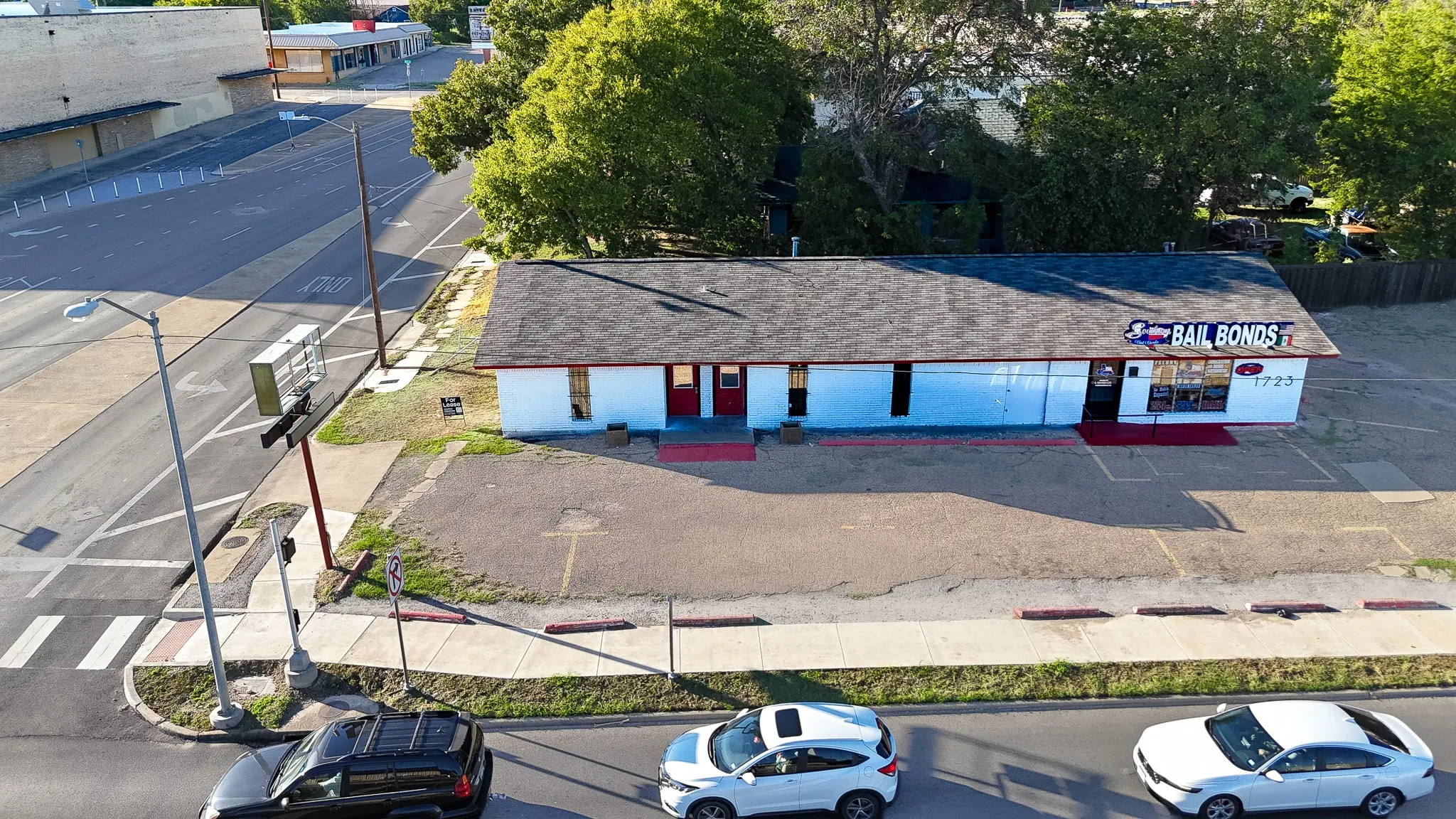 Commercial building with a dark shingle roof and white exterior facade