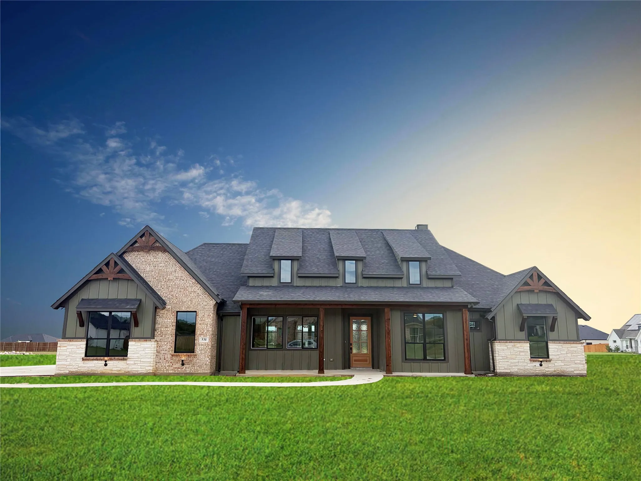 Craftsman-style exterior featuring a combination of brick, stone, and vertical siding
