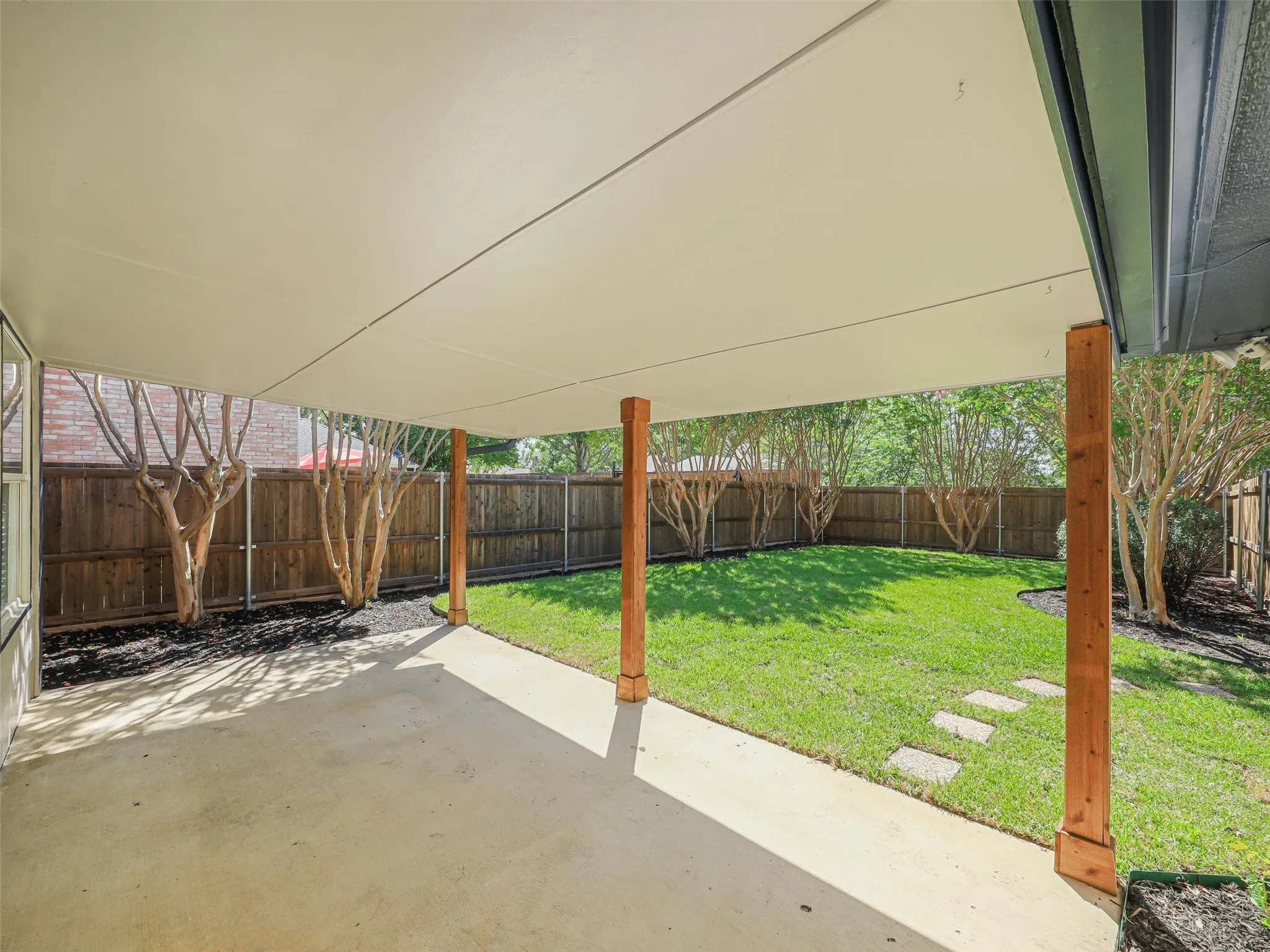 Covered concrete patio with wood support columns