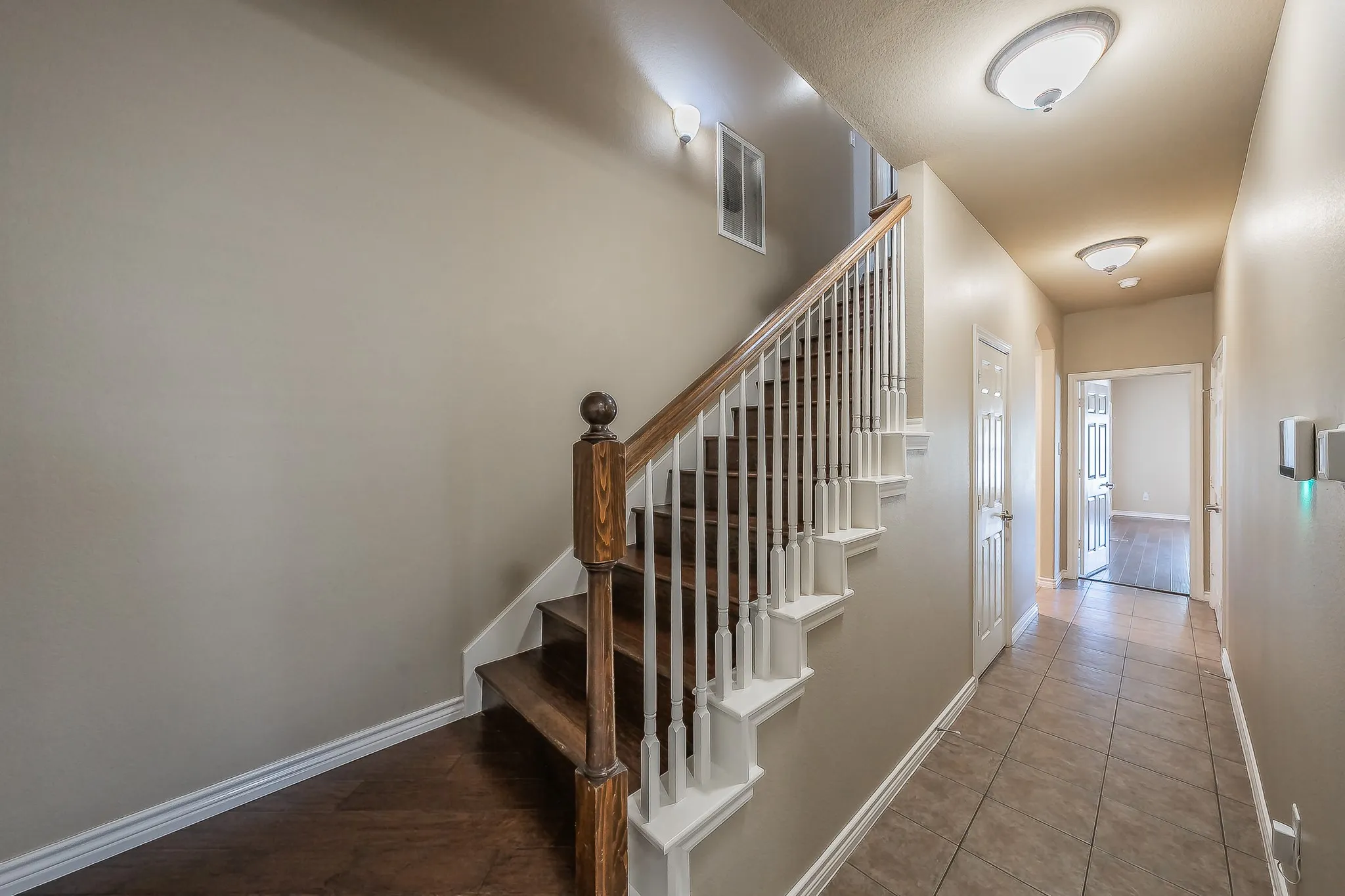 Hardwood staircase with white risers and balusters