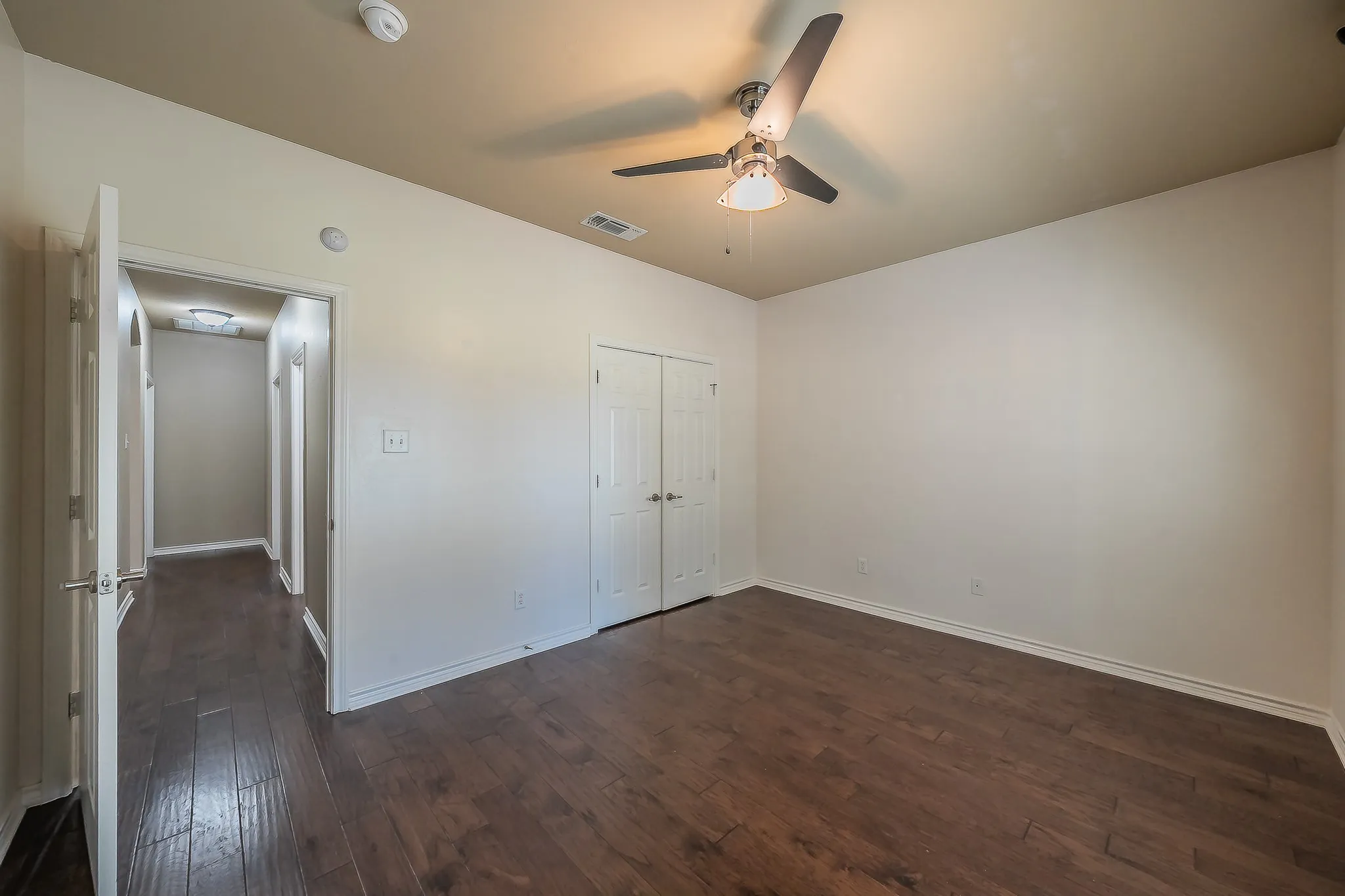 Dark wood-finish flooring with light-toned walls