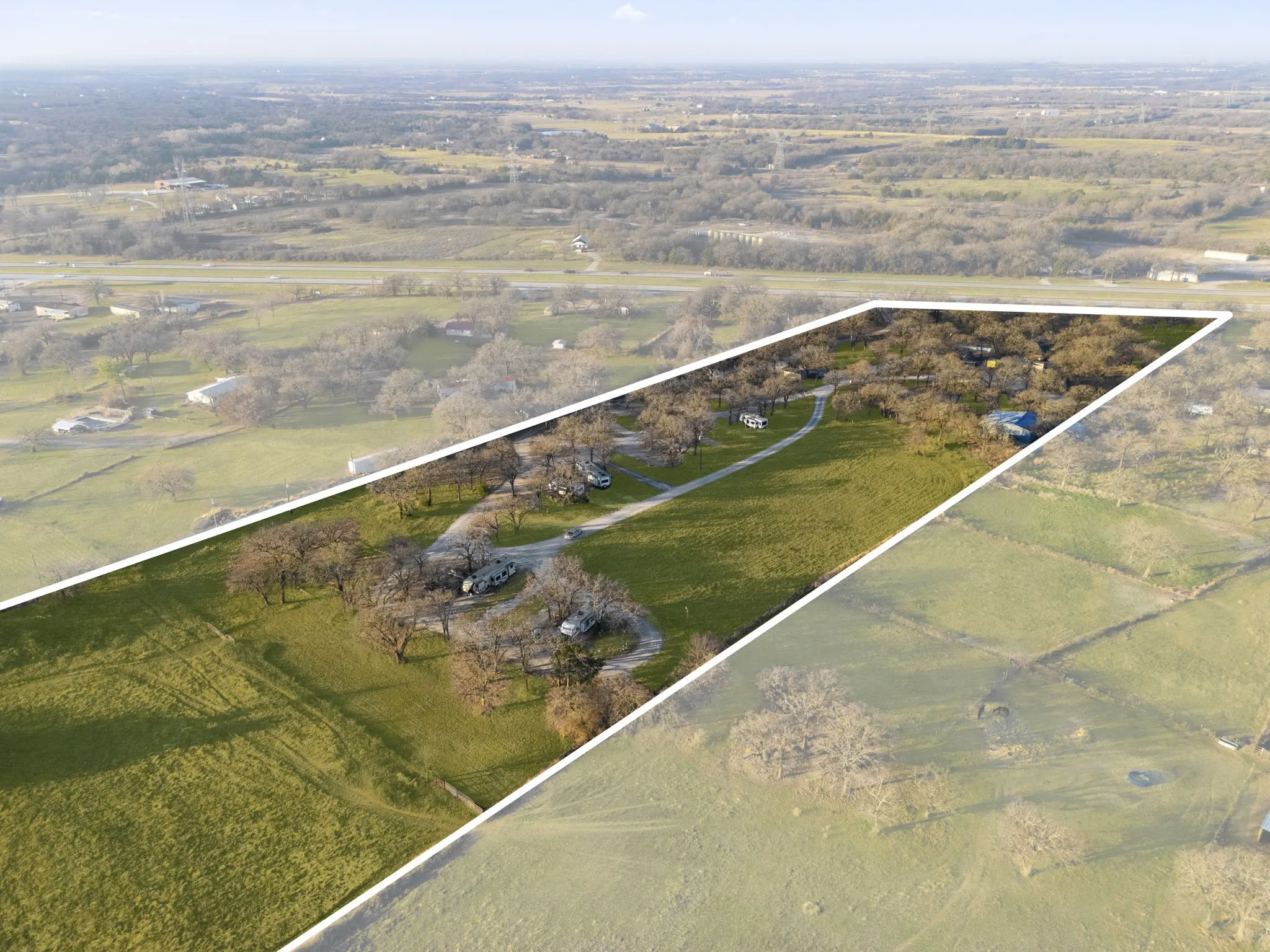 Expansive green space featuring mature trees and a defined property boundary