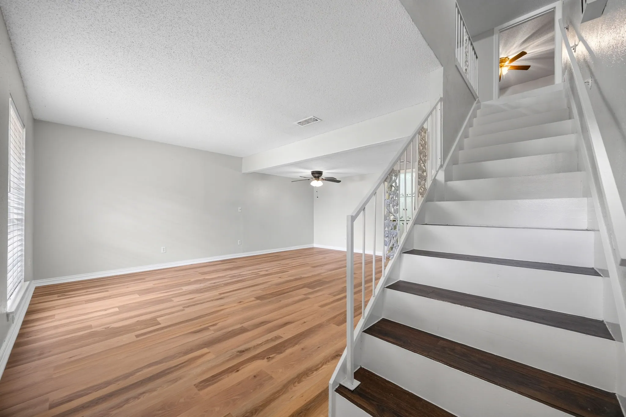 Staircase with white risers and dark wood-finish treads