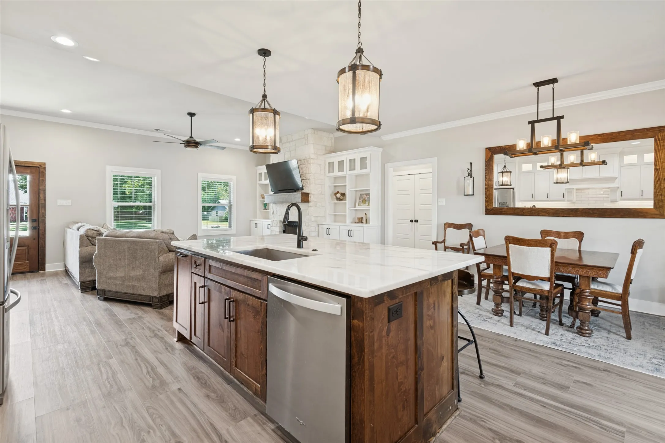 Central kitchen island with a built-in sink and stainless steel dishwasher