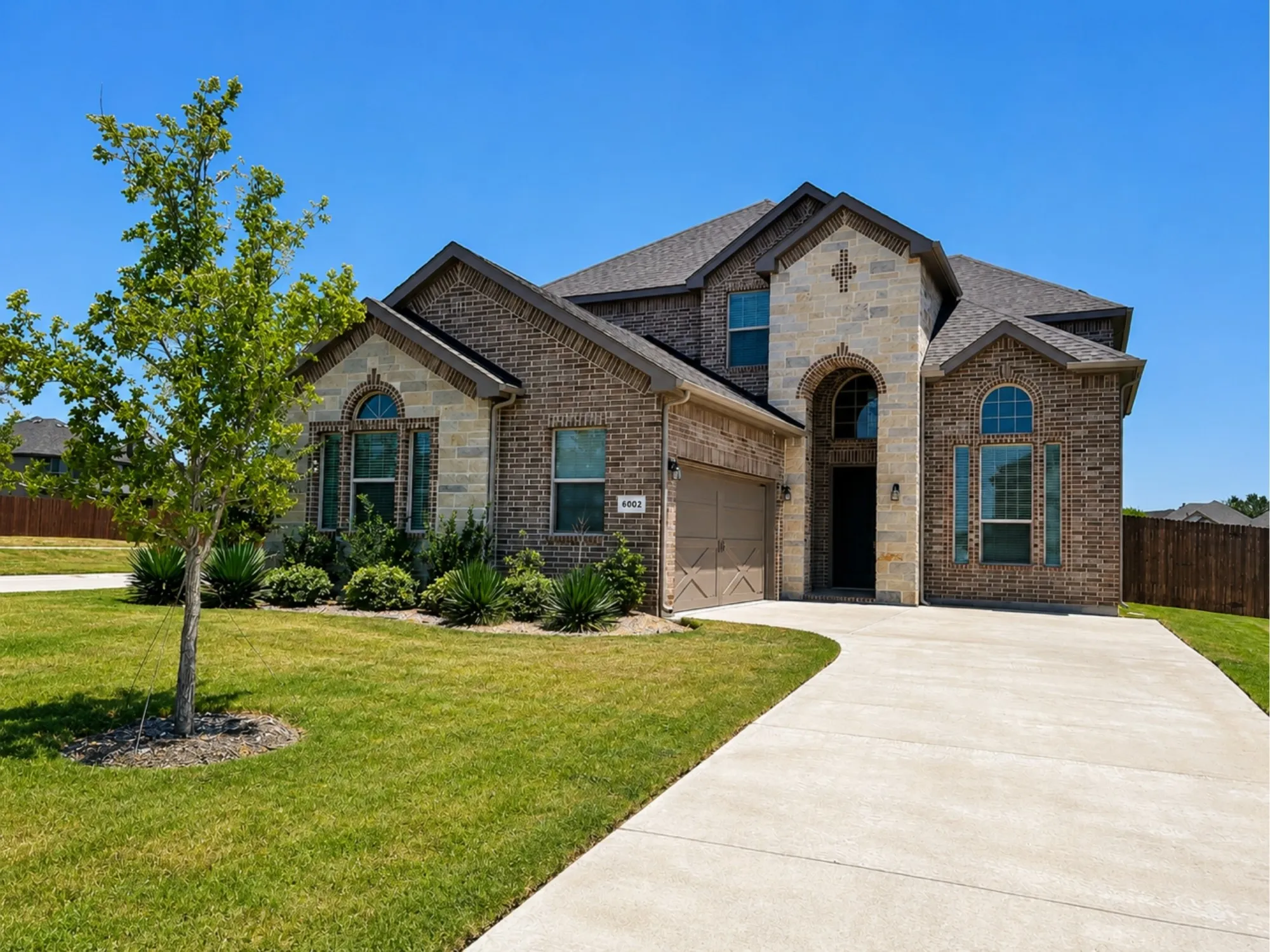 Stately brick and stone exterior with a prominent arched entry