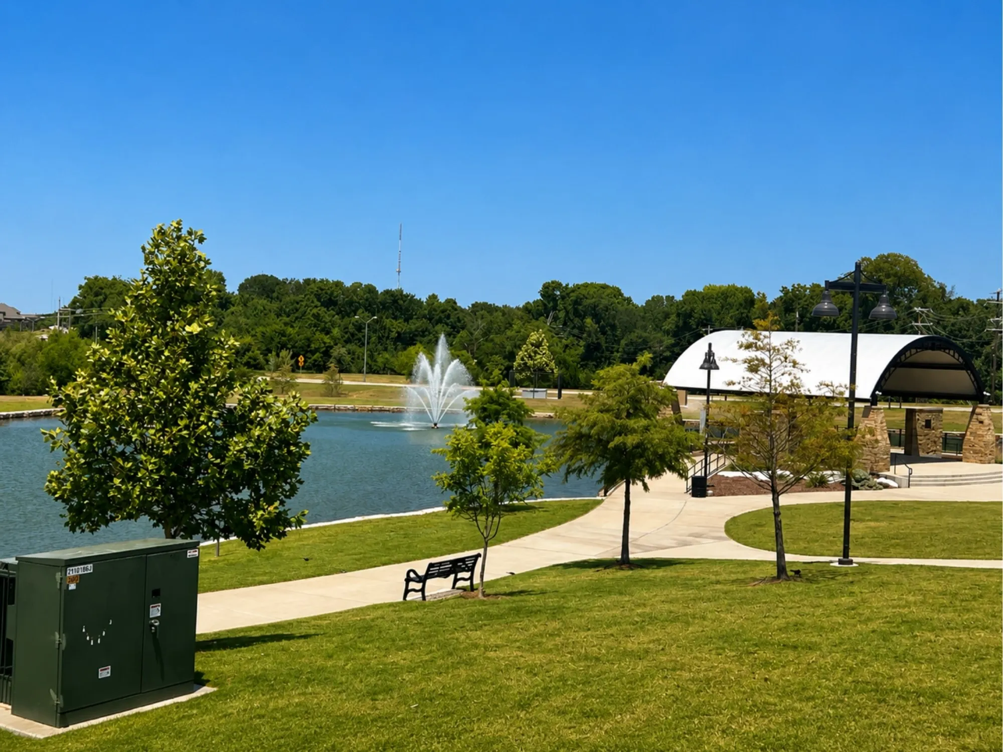 Landscaped park area featuring a central pond with a fountain