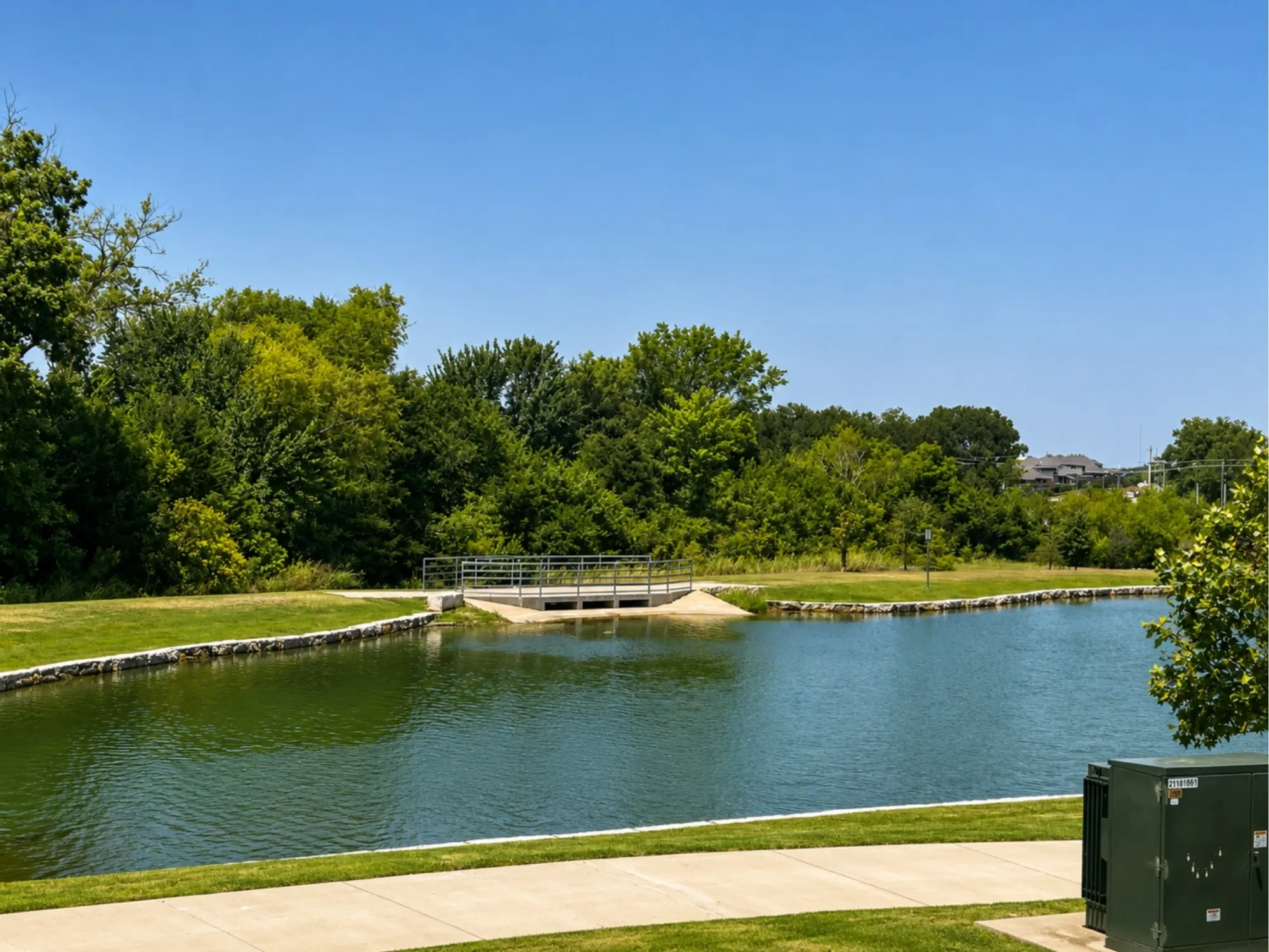 Manicured green space bordering a tranquil pond