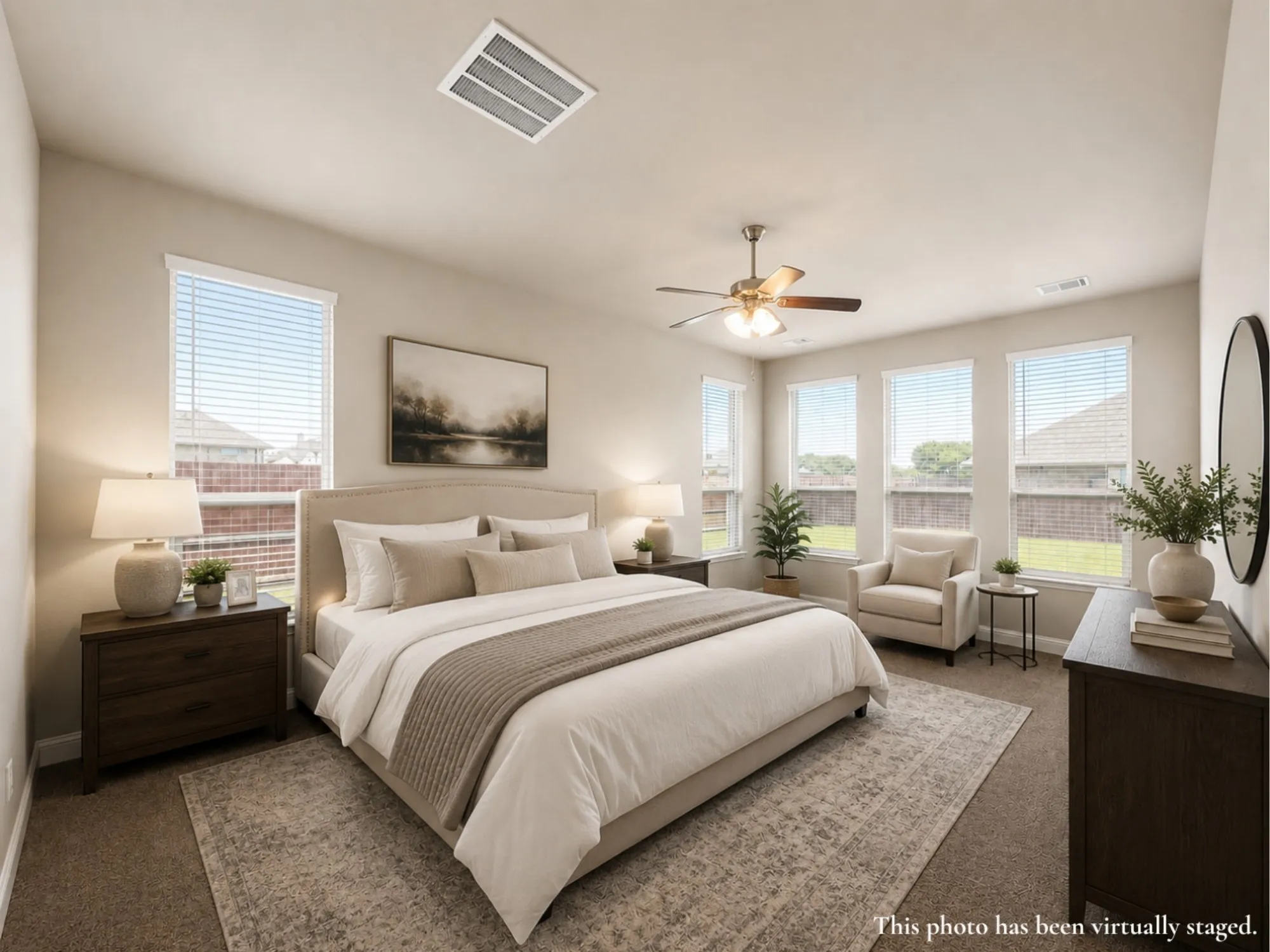 Bedroom with multiple windows, neutral wall tones, textured carpeting, and a ceiling fan