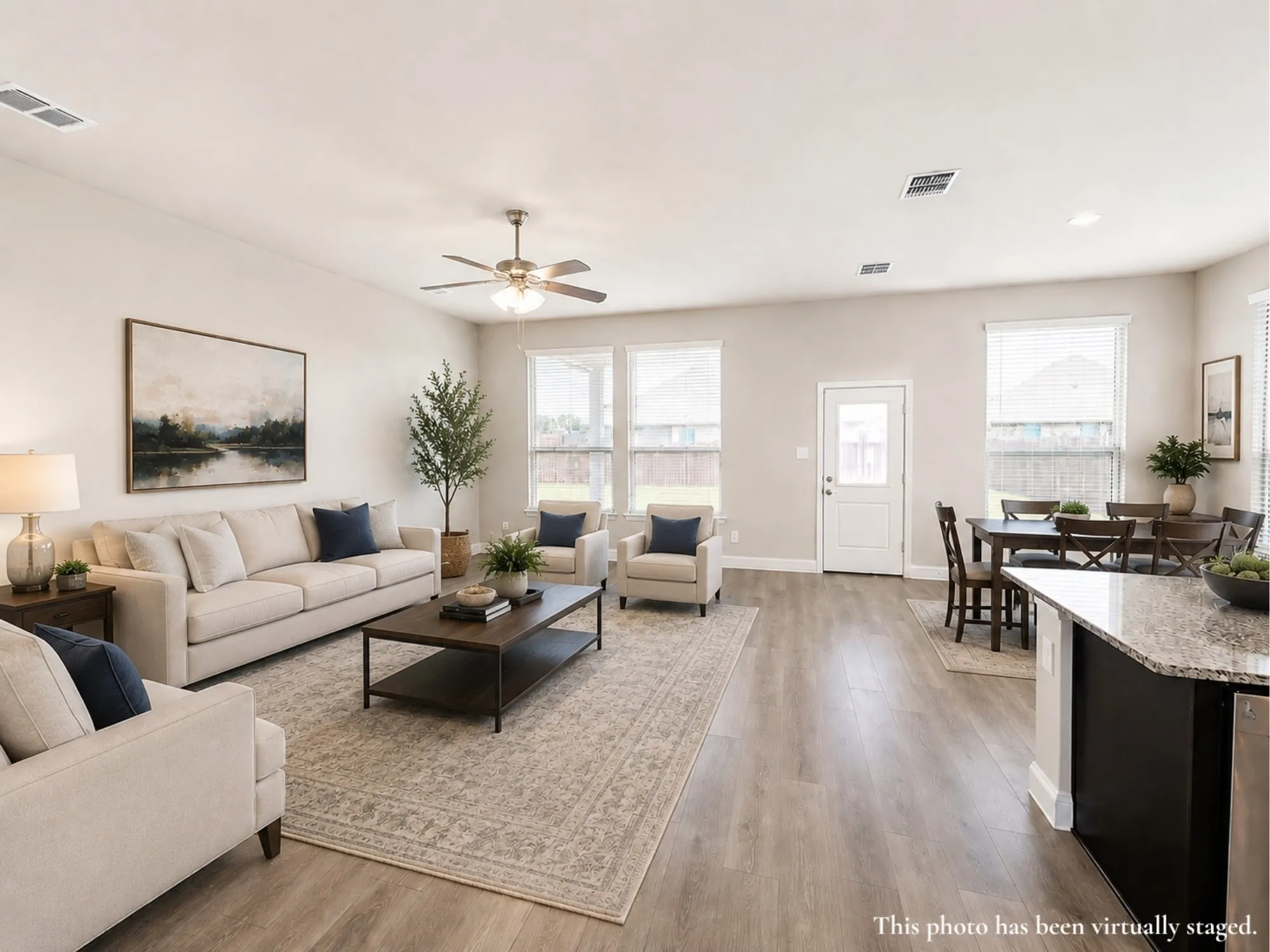 Open-concept living space featuring wood-finish flooring, recessed lighting, and a ceiling fan