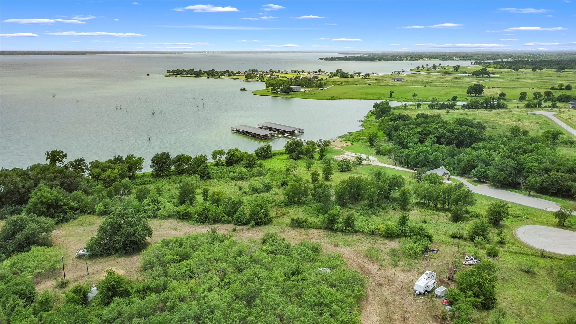 Expansive water frontage with established boat docks and verdant natural landscaping