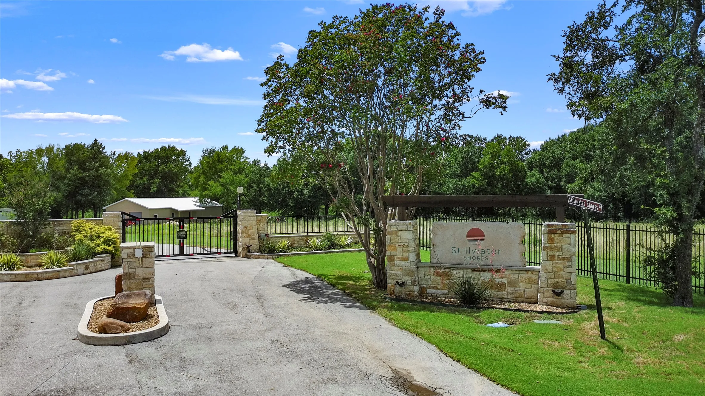 Stone entry monument with wood beam accent