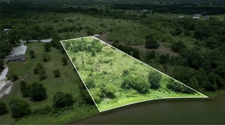 Expansive land parcel featuring mature trees and natural vegetation