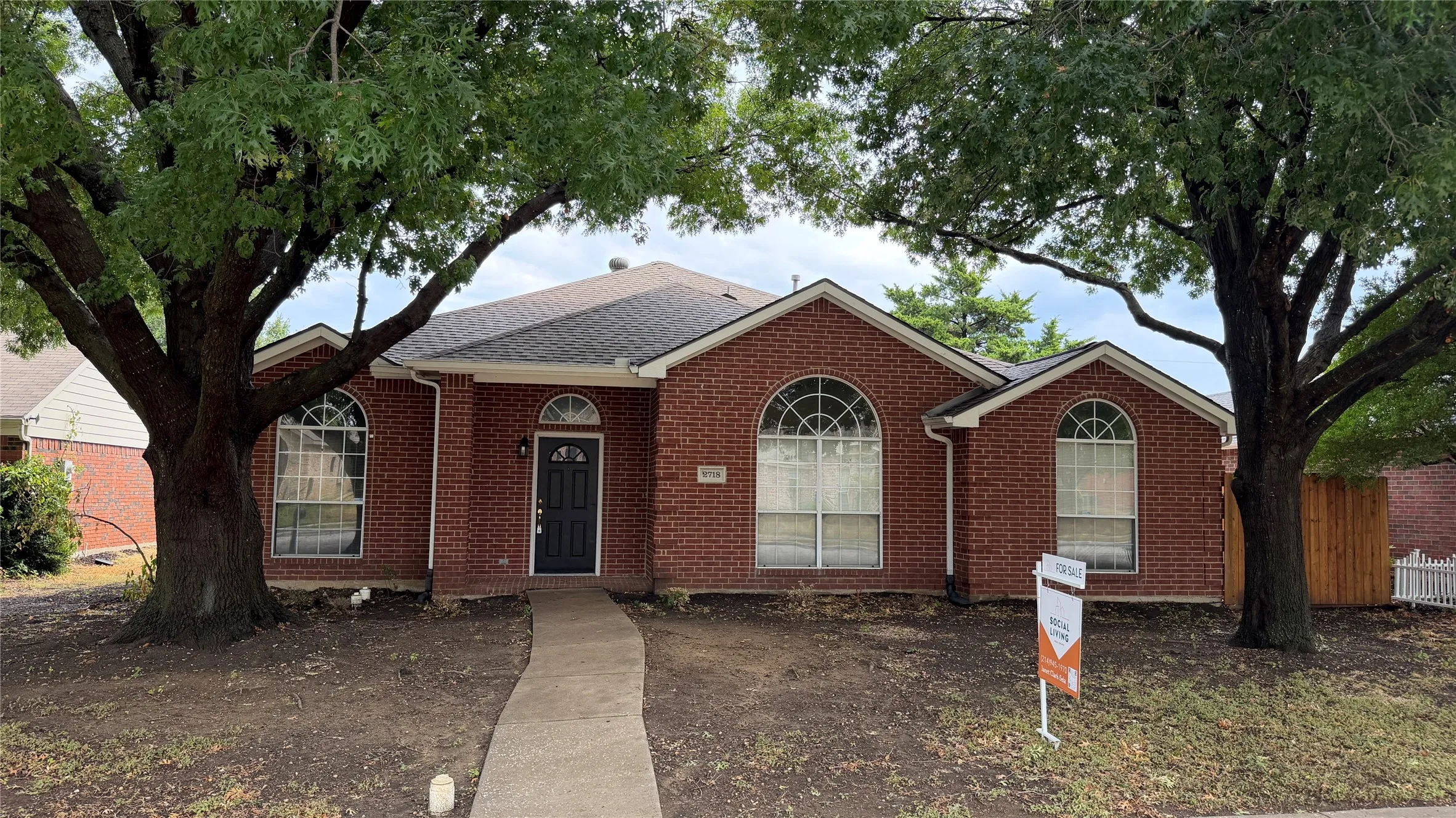 Brick exterior with a gabled roof and arched windows
