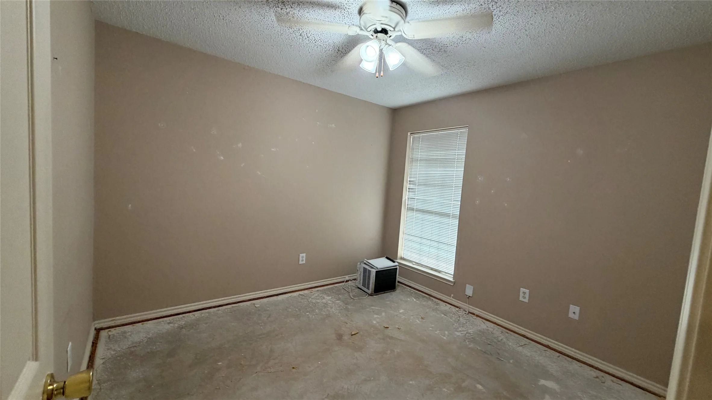 Room featuring a ceiling fan with integrated lighting, a window with horizontal blinds, and neutral-toned walls