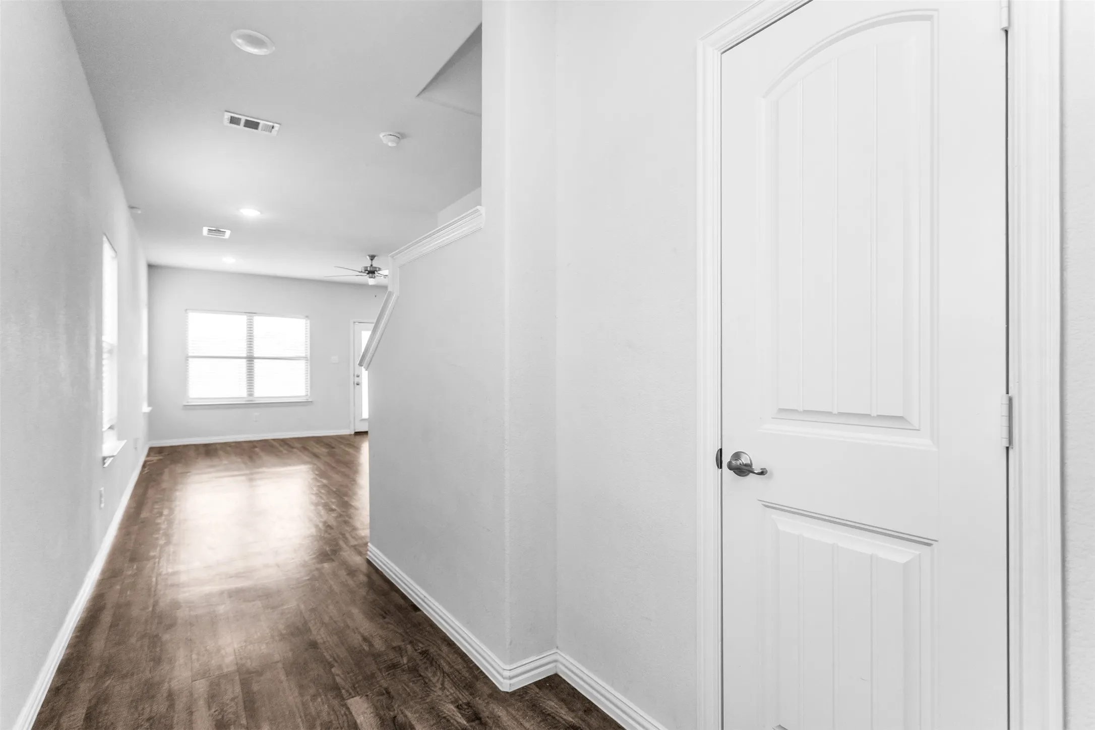Recessed lighting, wood-finish flooring, white trim, and multiple windows
