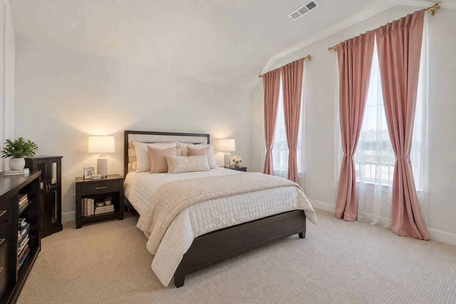 Plush carpeting, two large windows, elegant window treatments, and a built-in upholstered headboard