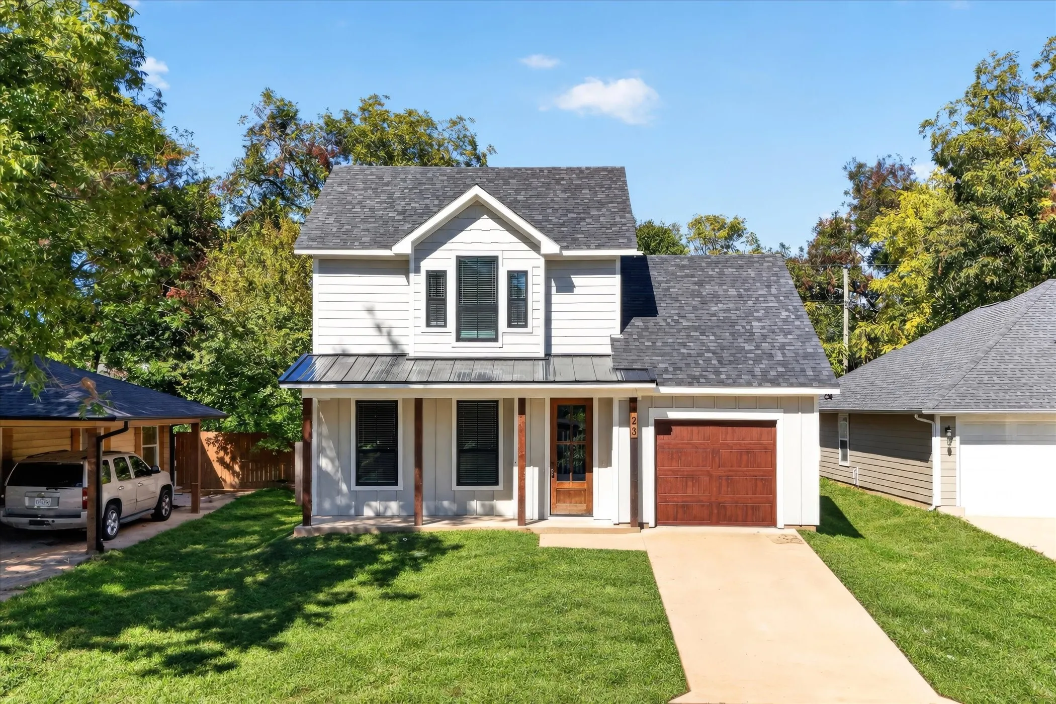 Picture-perfect! Covered front porch and a garage!