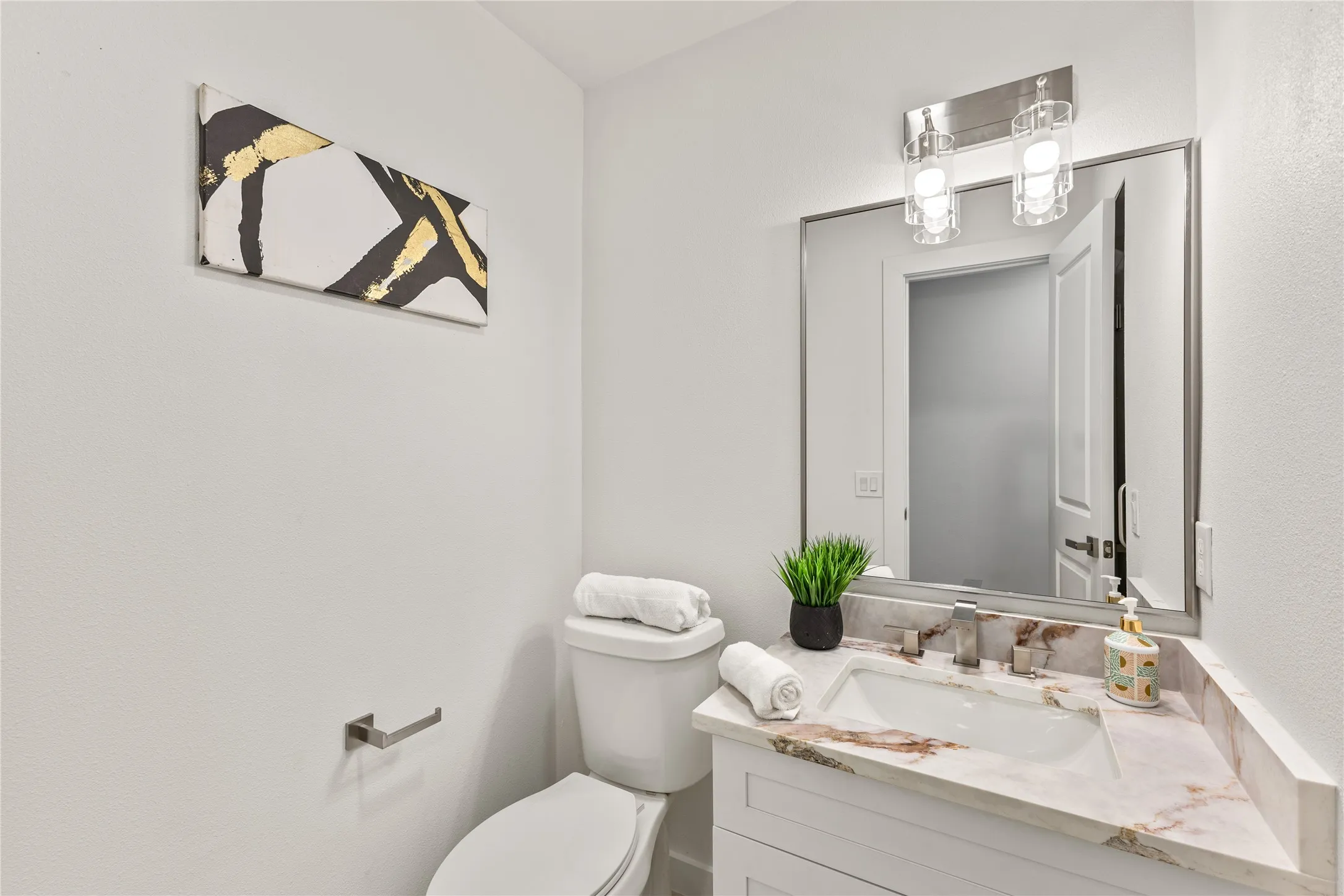 White vanity with an integrated sink and stone countertop