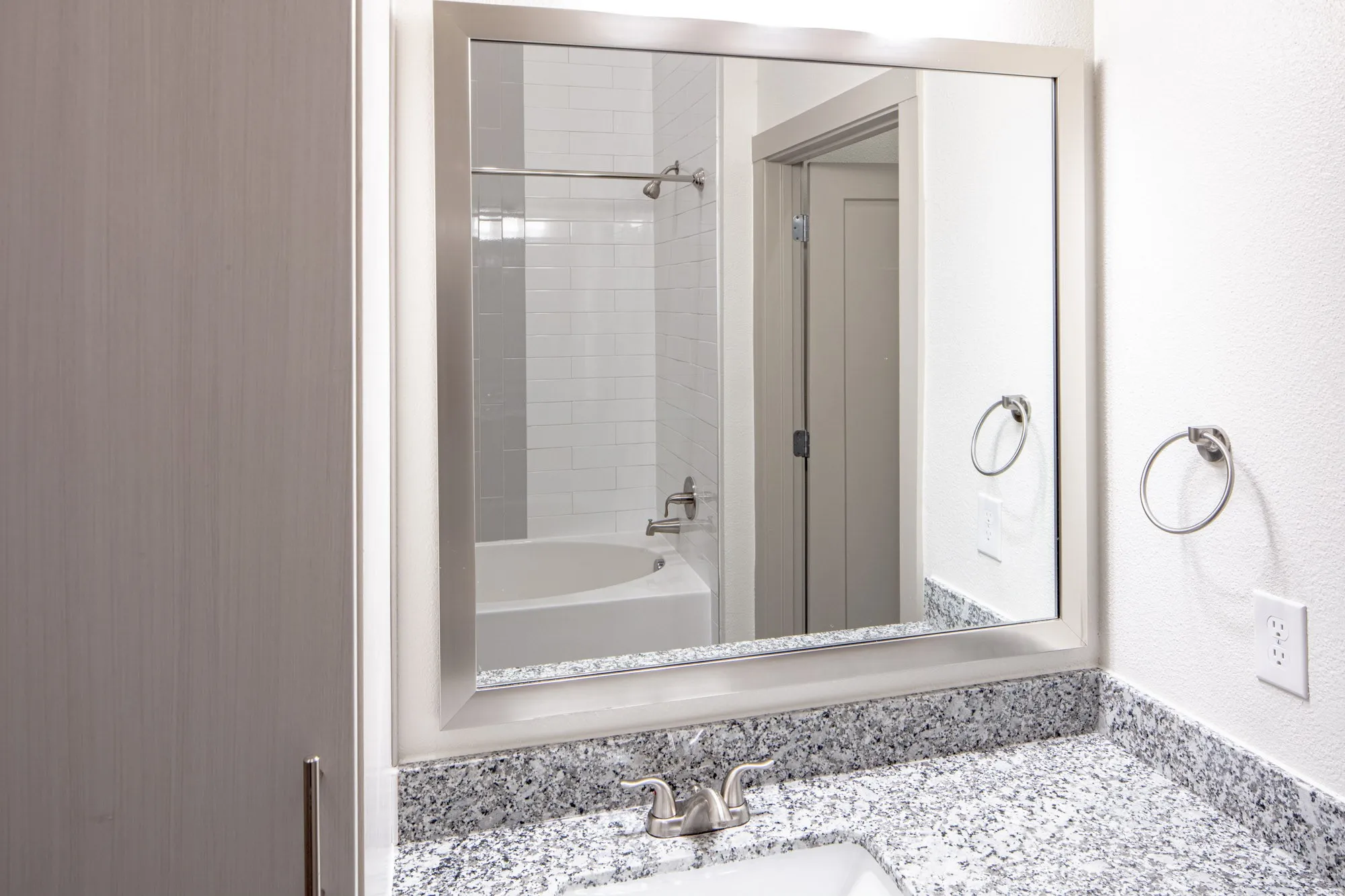 Bathroom with tiled shower / bath combo and vanity