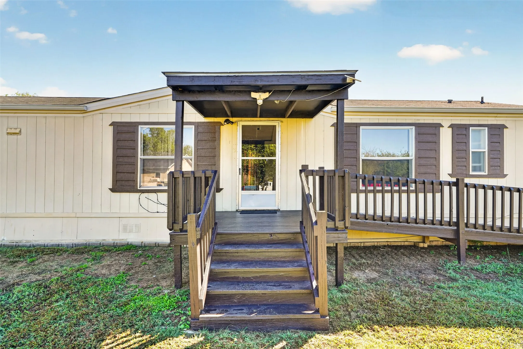 Covered porch entry with steps, exterior siding, and window shutters