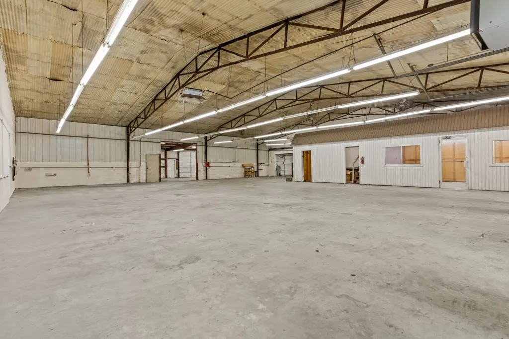 Expansive concrete flooring with a high trussed ceiling
