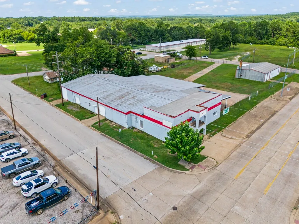 Commercial building featuring a light gray exterior with red trim