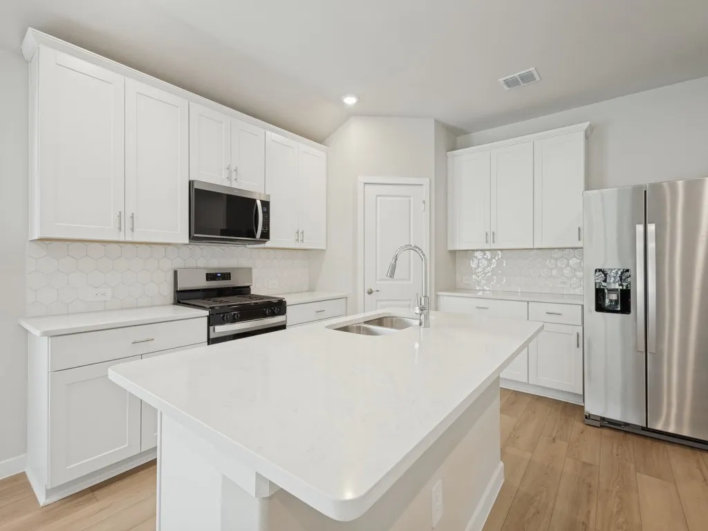 Kitchen with stainless steel appliances and a walk-in pantry