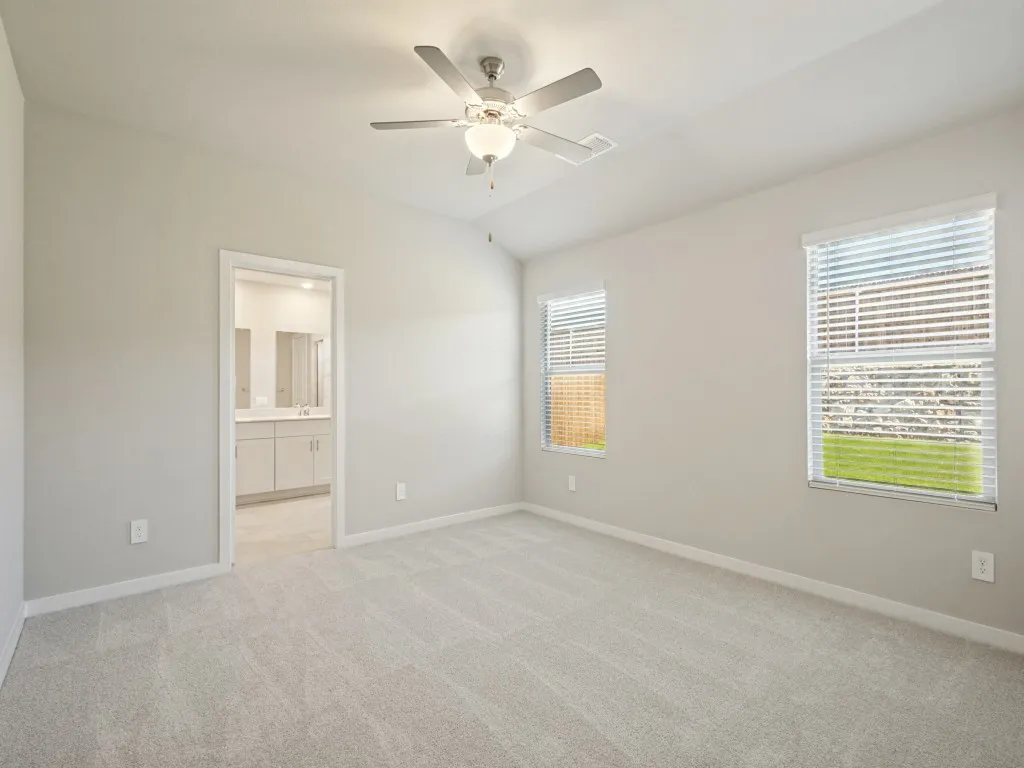 Primary bedroom with a ceiling fan