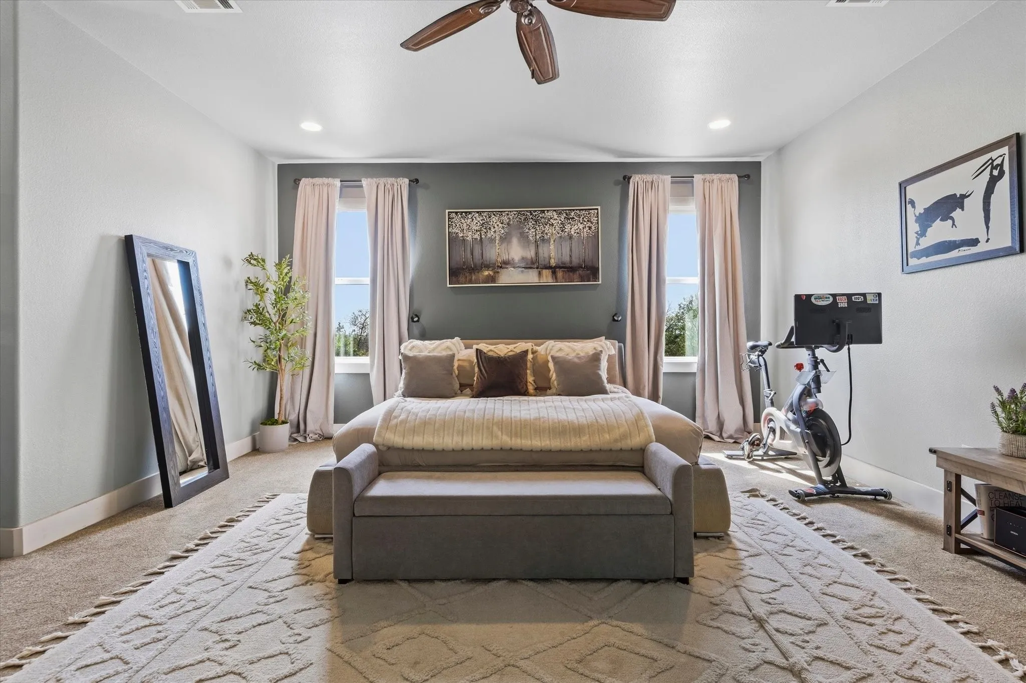Carpeted flooring, recessed lighting, ceiling fan, and two windows with drapes