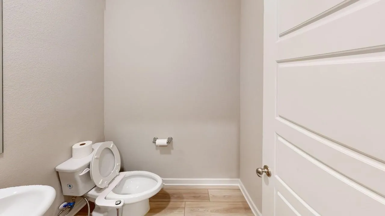 Light wood-finish flooring with a white trim