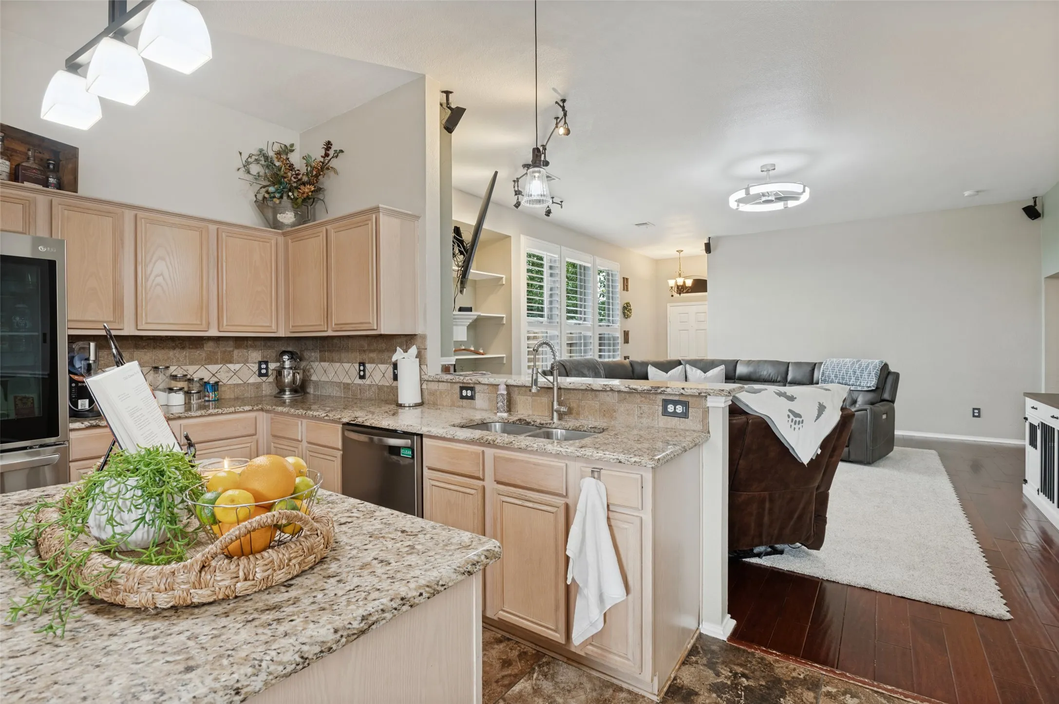 Kitchen featuring light wood-finish cabinetry, granite countertops, and stainless steel appliances