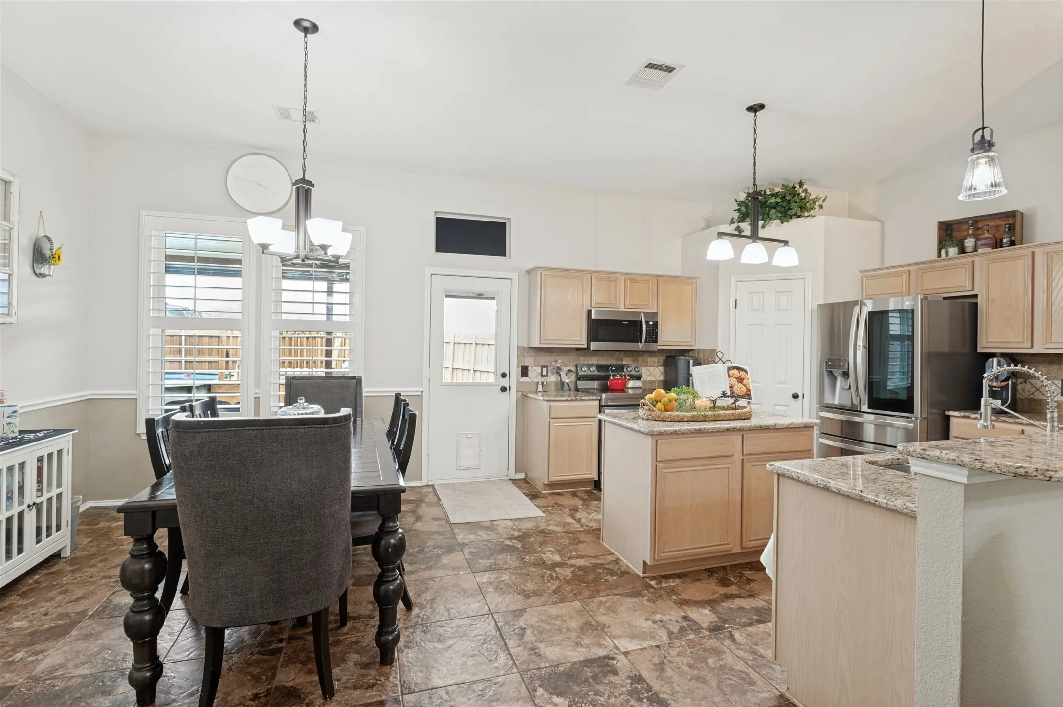 Kitchen featuring a central island, recessed lighting, and stainless steel appliances