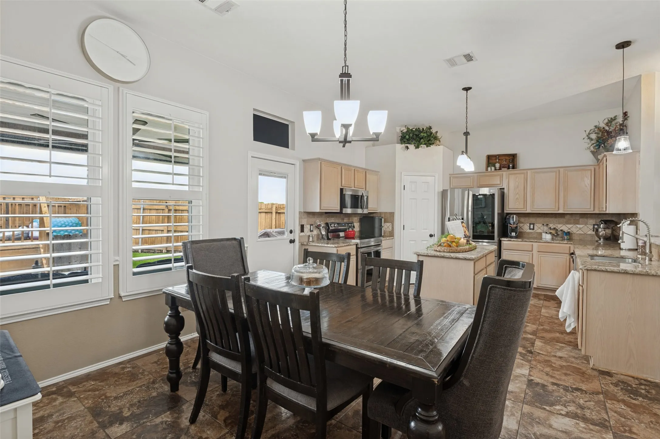 Kitchen featuring light wood-finish cabinetry, granite countertops, and stainless steel appliances
