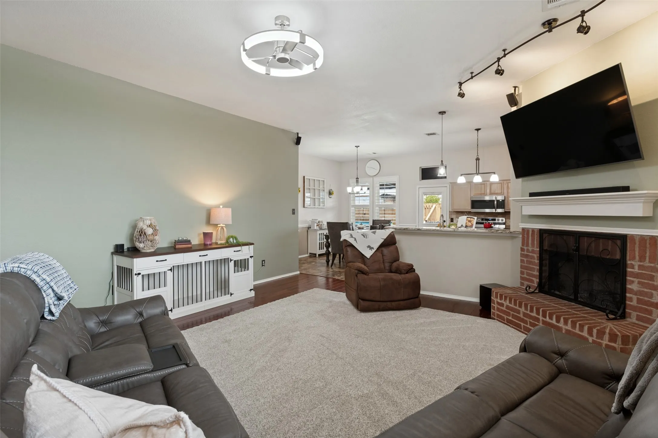 Fireplace with red brick surround and white mantel
