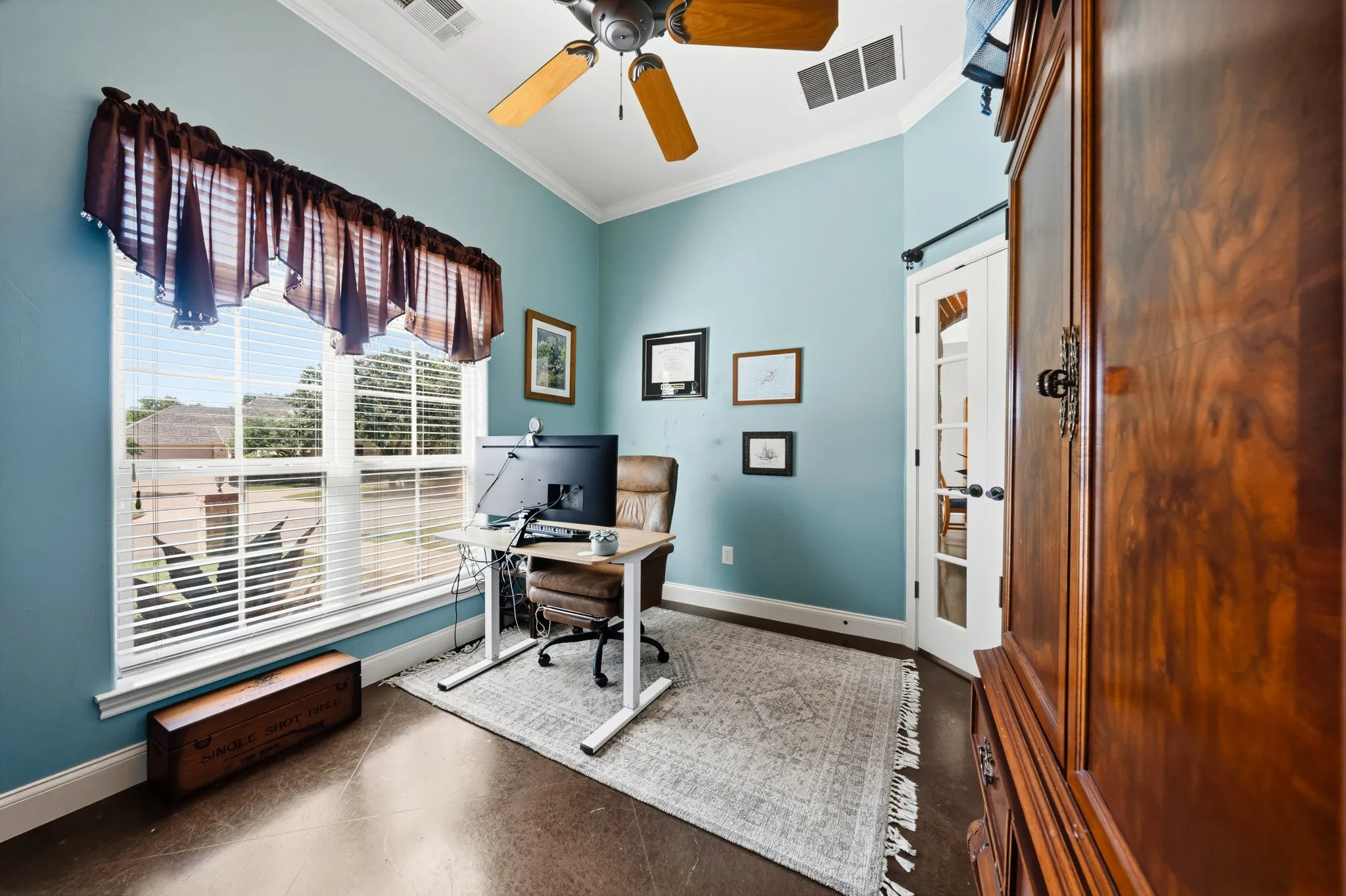Vaulted ceiling with a ceiling fan, French doors, and large windows with blinds