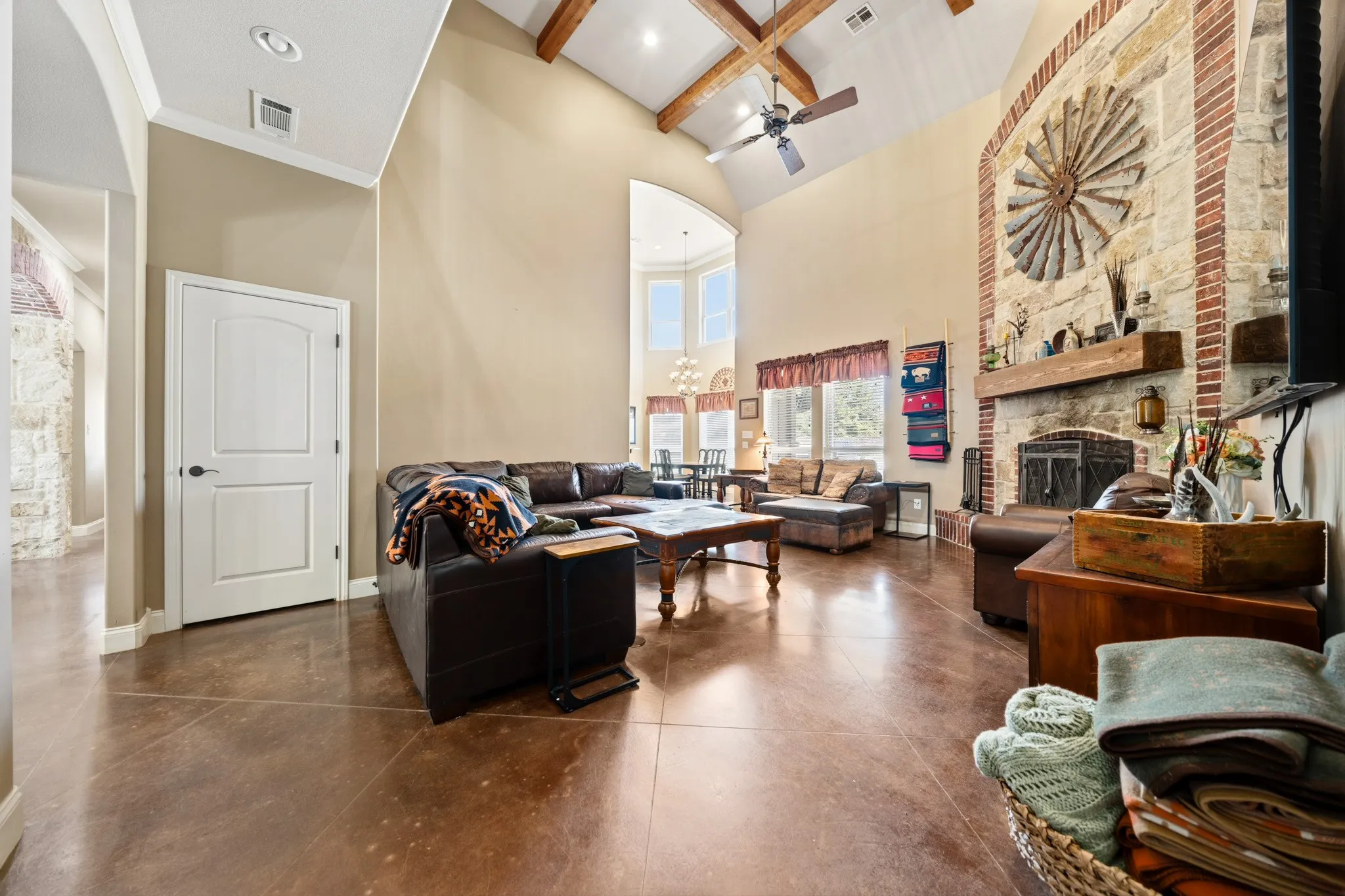 Vaulted ceiling with exposed wood beams, ceiling fan, and recessed lighting
