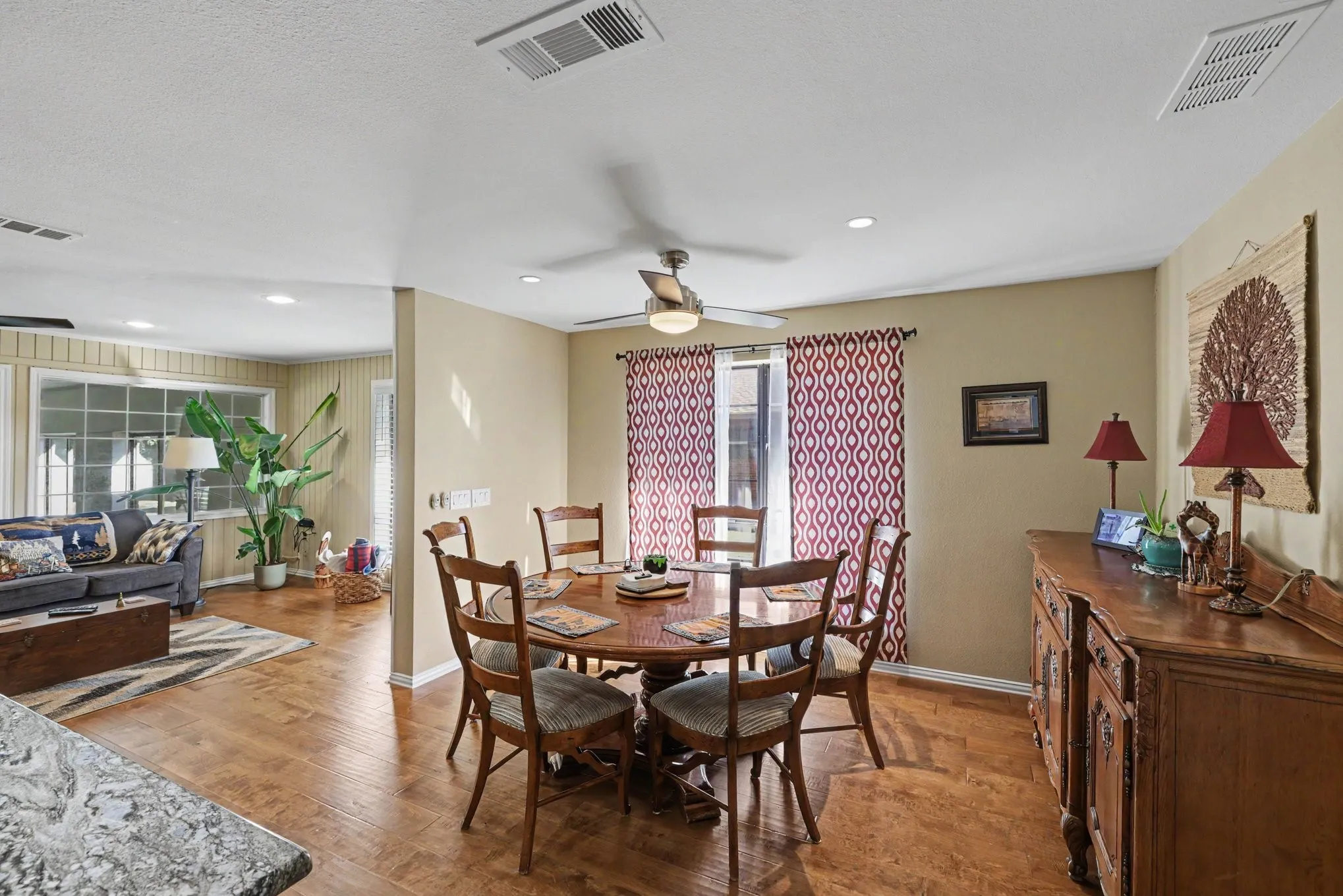 Wood-finish flooring throughout, recessed lighting, and a ceiling fan with integrated lighting