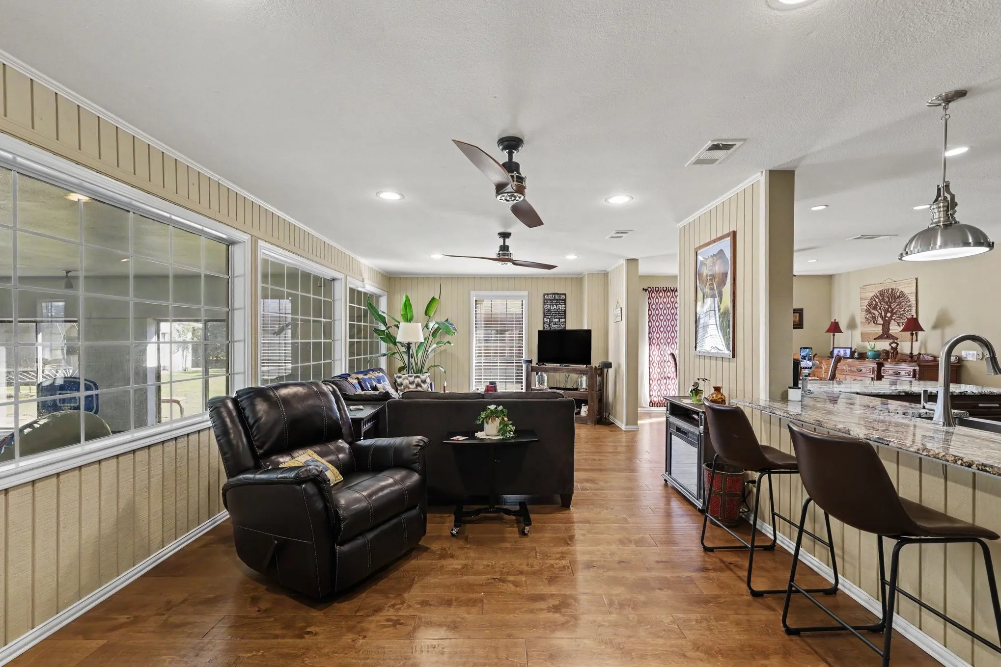 Wood-finish flooring throughout, recessed lighting, and multiple ceiling fans