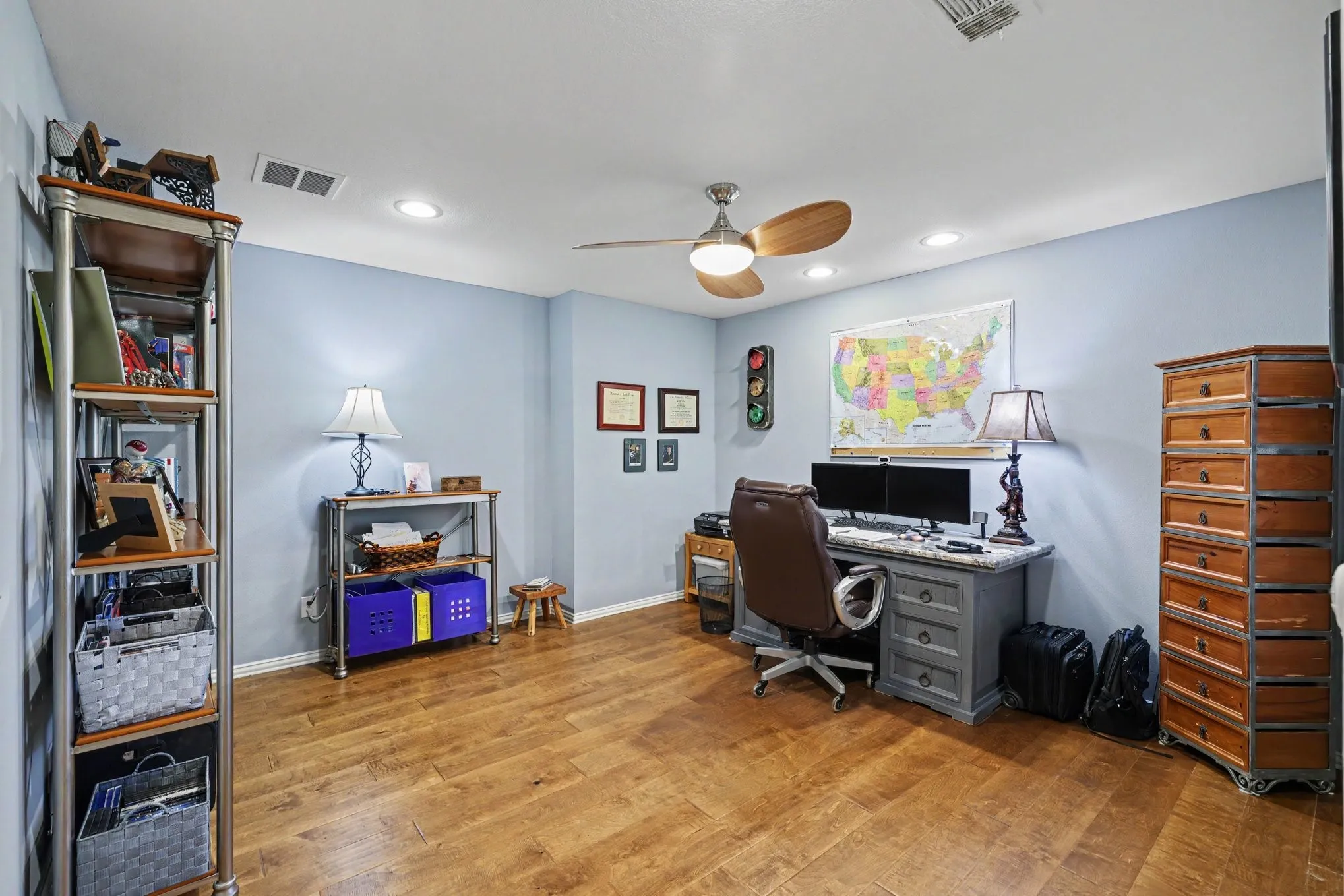 Wood-finish flooring, recessed lighting, and a ceiling fan with integrated lighting