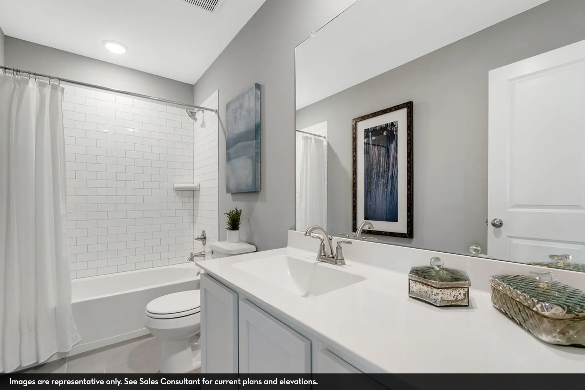 Bathroom featuring a white subway tile shower surround, a built-in bathtub, a single vanity with a white countertop, and a large wall-mounted mirror