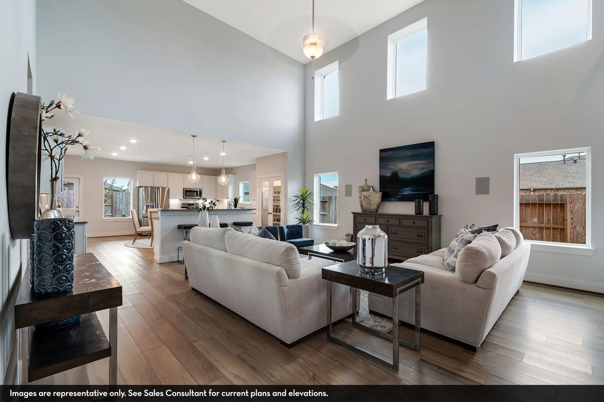 Vaulted ceilings, wood-finish flooring, recessed lighting, and an open-concept layout