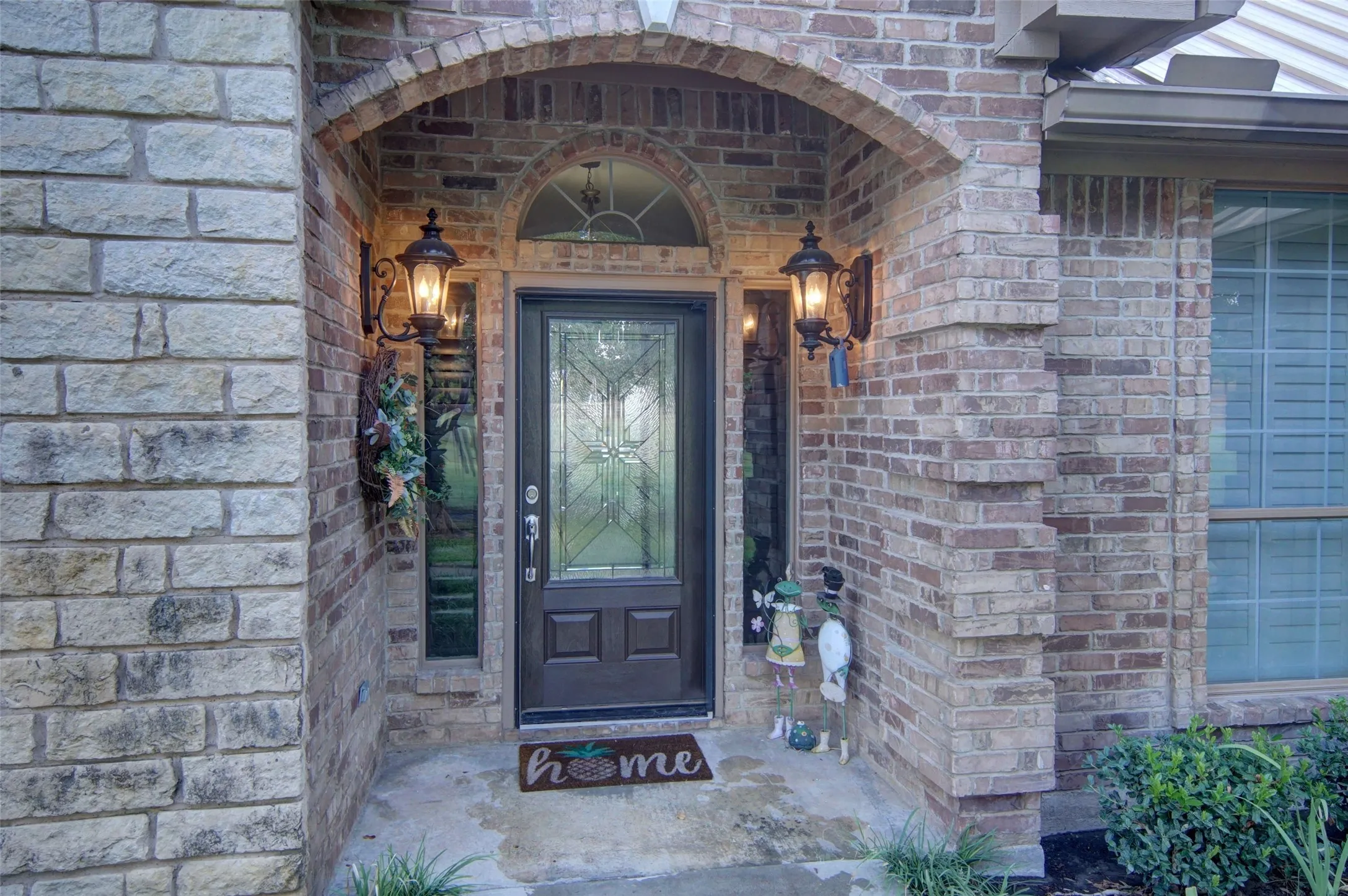 Brick and stone façade with arched entryway