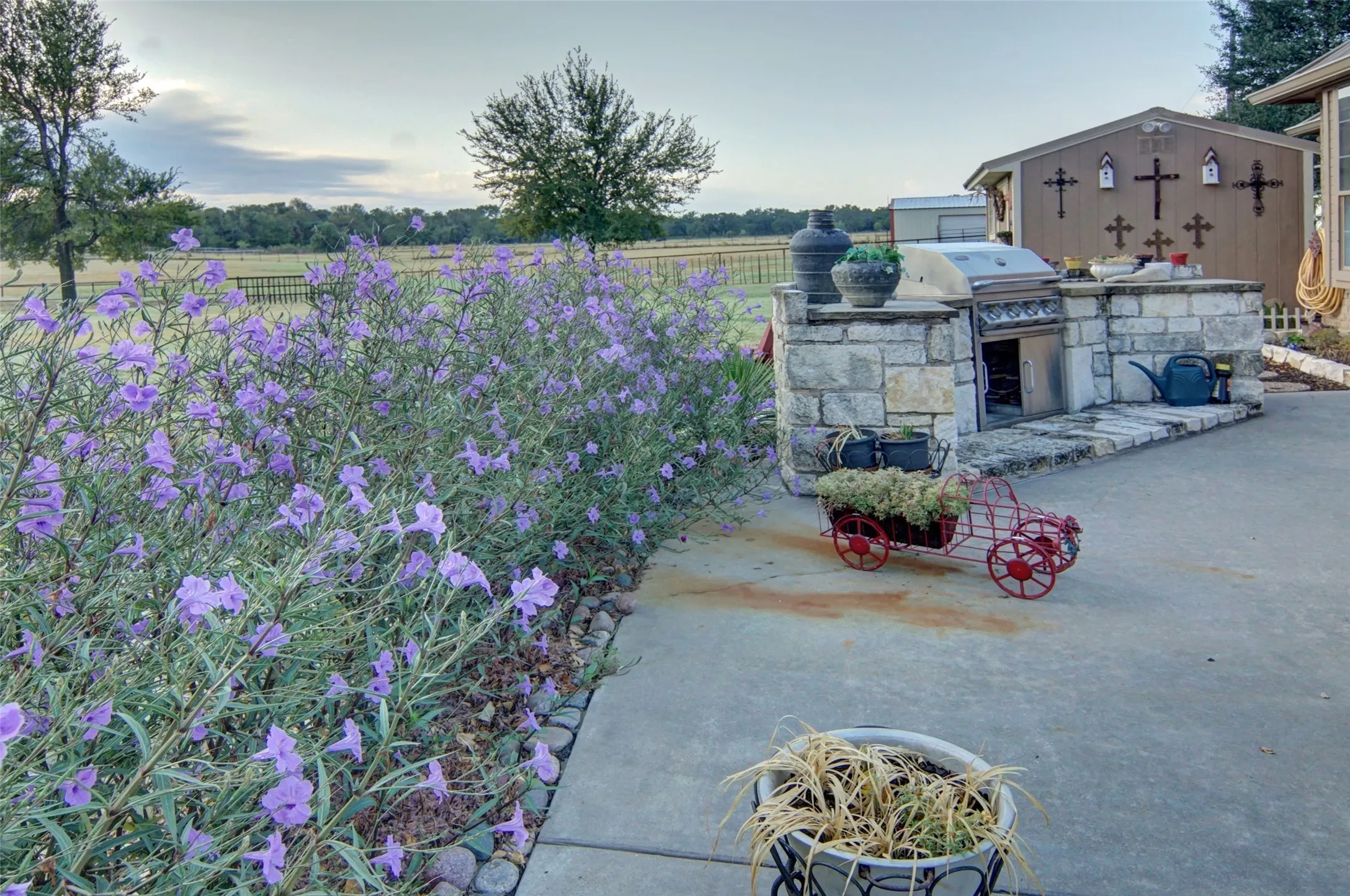 Outdoor kitchen with stone construction, integrated grill, and counter space