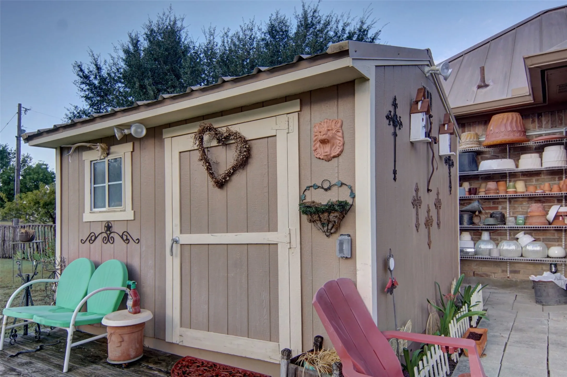 Shed with vertical plank siding, a metal roof, and a single window