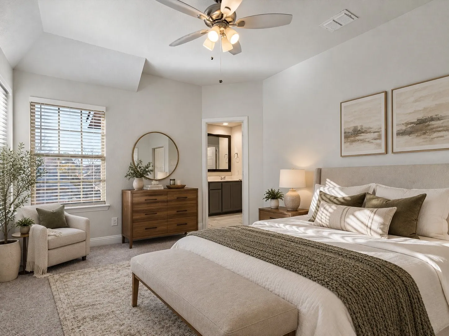 Tray ceiling with a ceiling fan, window with blinds, wood-finish dresser with a round mirror, and an upholstered headboard